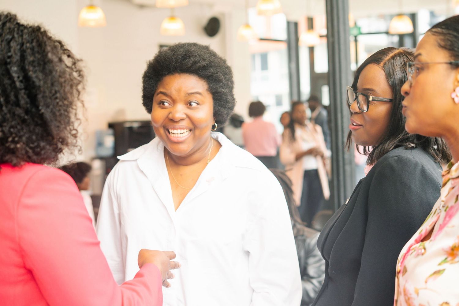 A lively group conversation taking place in a bright indoor space.