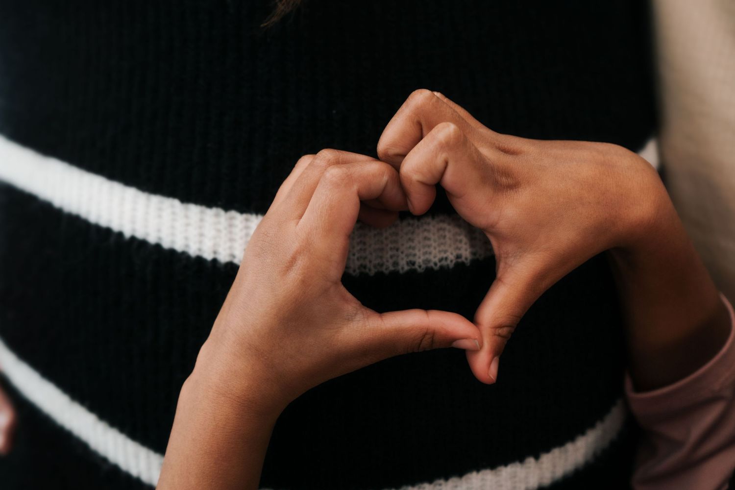 Close-up shot of hands during an intimate indoor photoshoot.