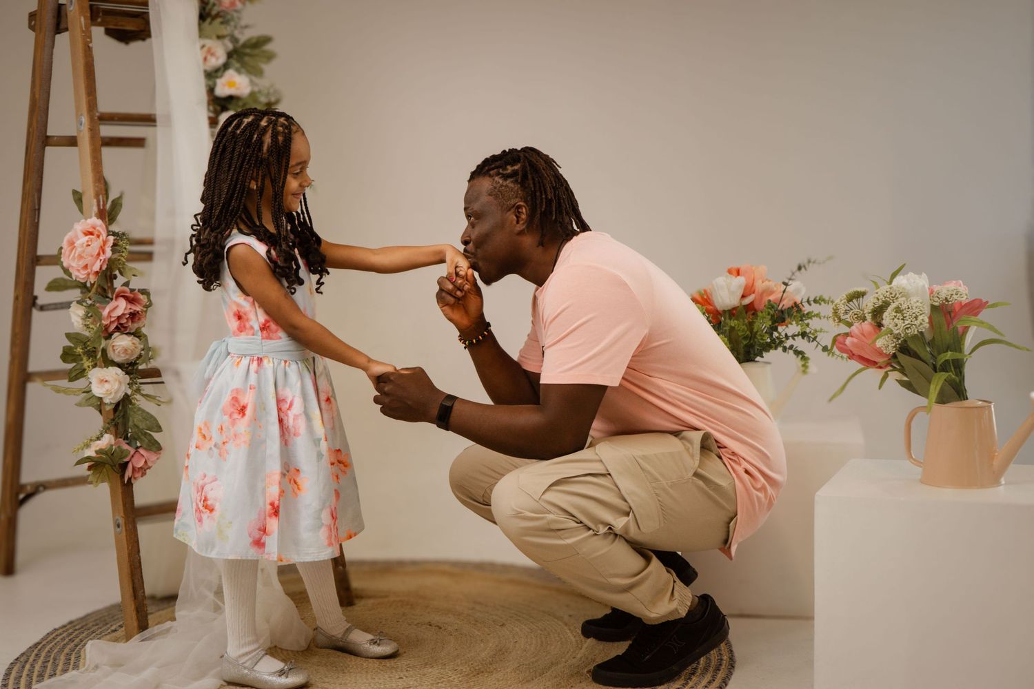 A series of connected photos showing a tender proposal moment in a studio decorated with pink flowers and a wooden ladder.