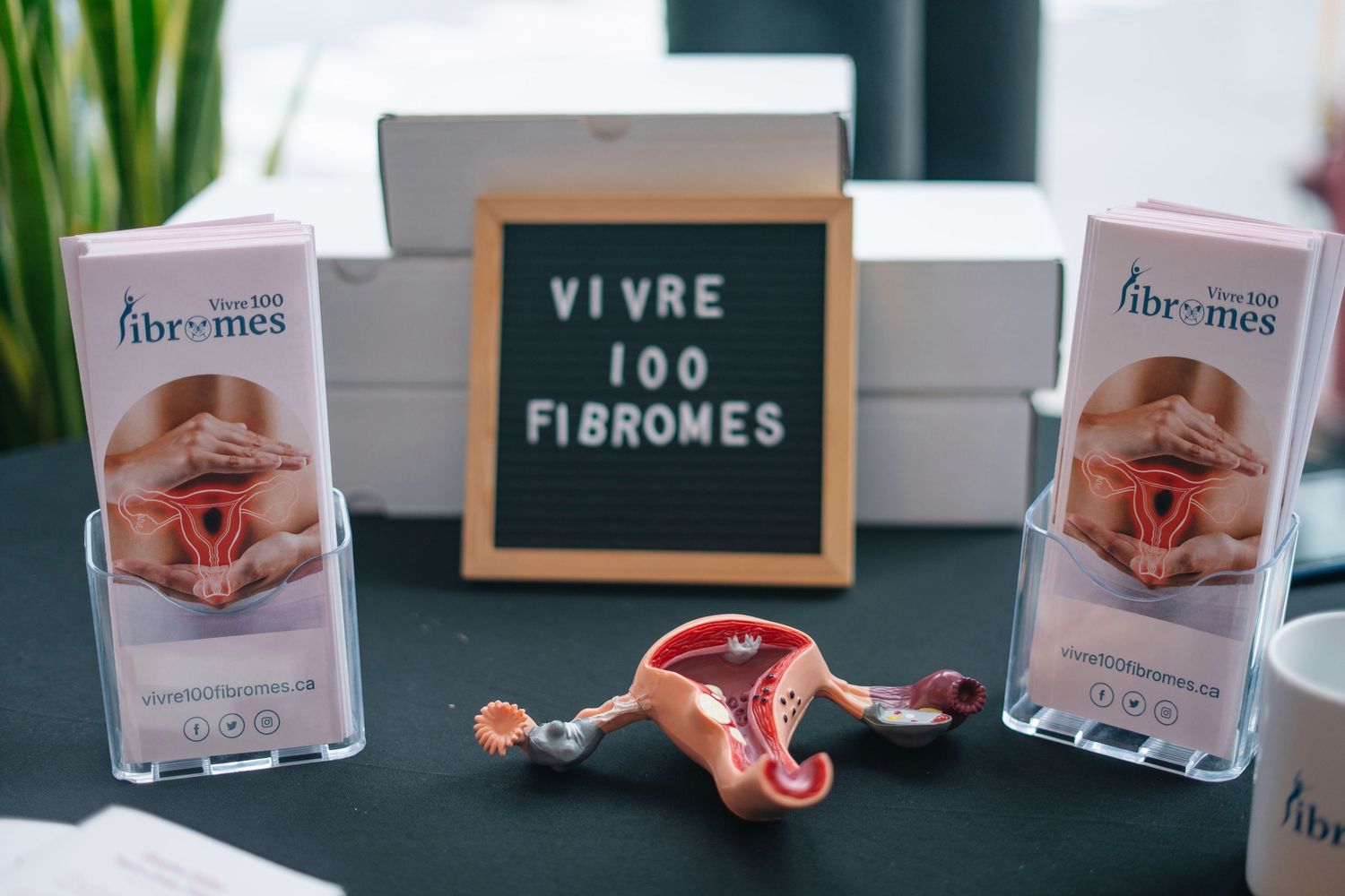 Medical or healthcare product boxes and marketing materials displayed on a dark surface.