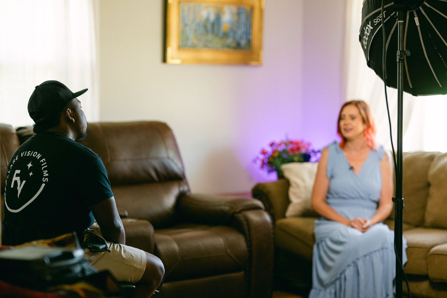 Film production scene with lighting equipment and casual interview setup.