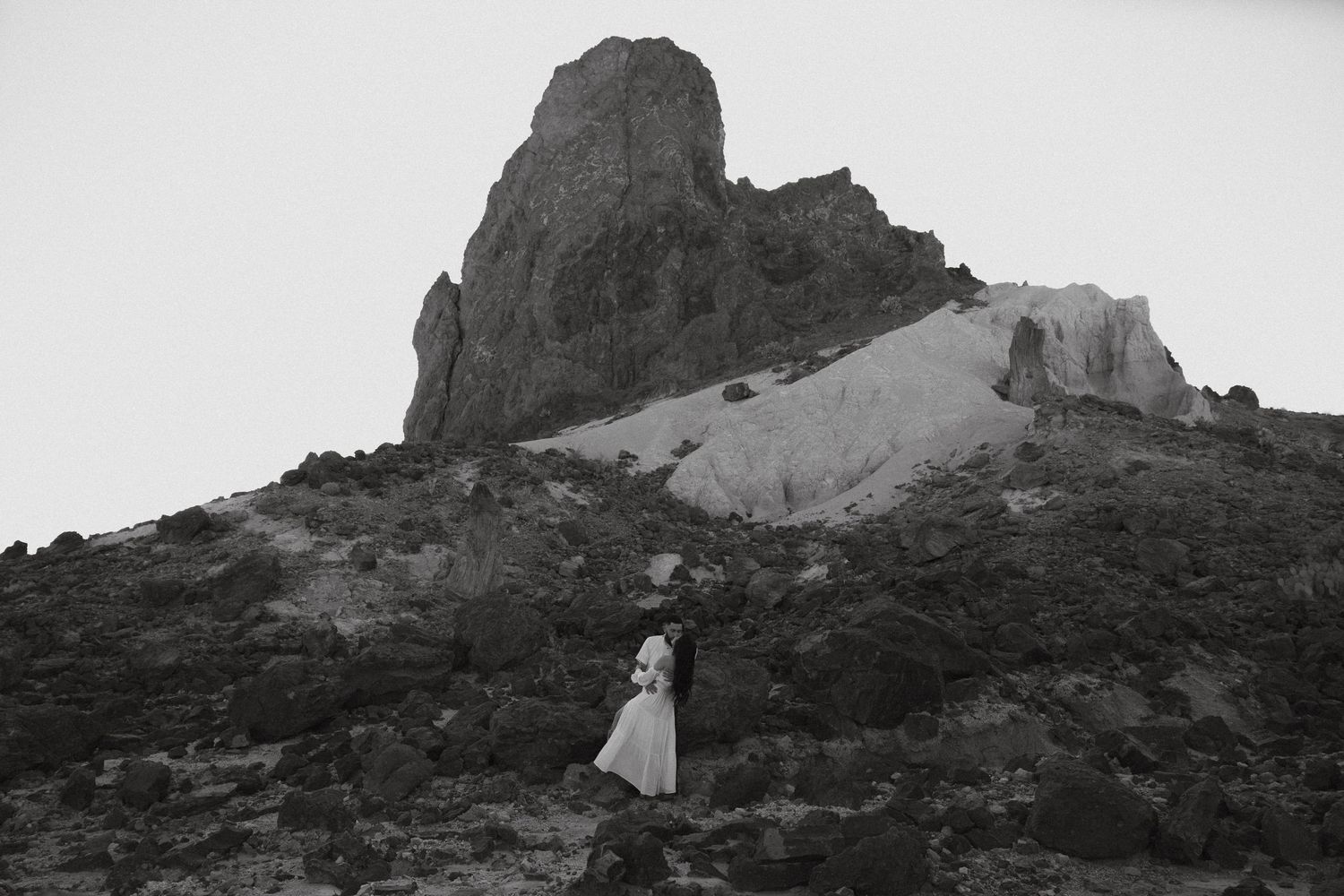 Black and white landscape photo series showing scenic rock formations and mountainous desert terrain at sunset.