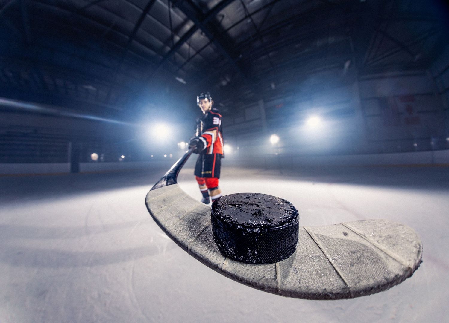 Anaheim Ducks player with puck on a hockey stick with a fisheye lens