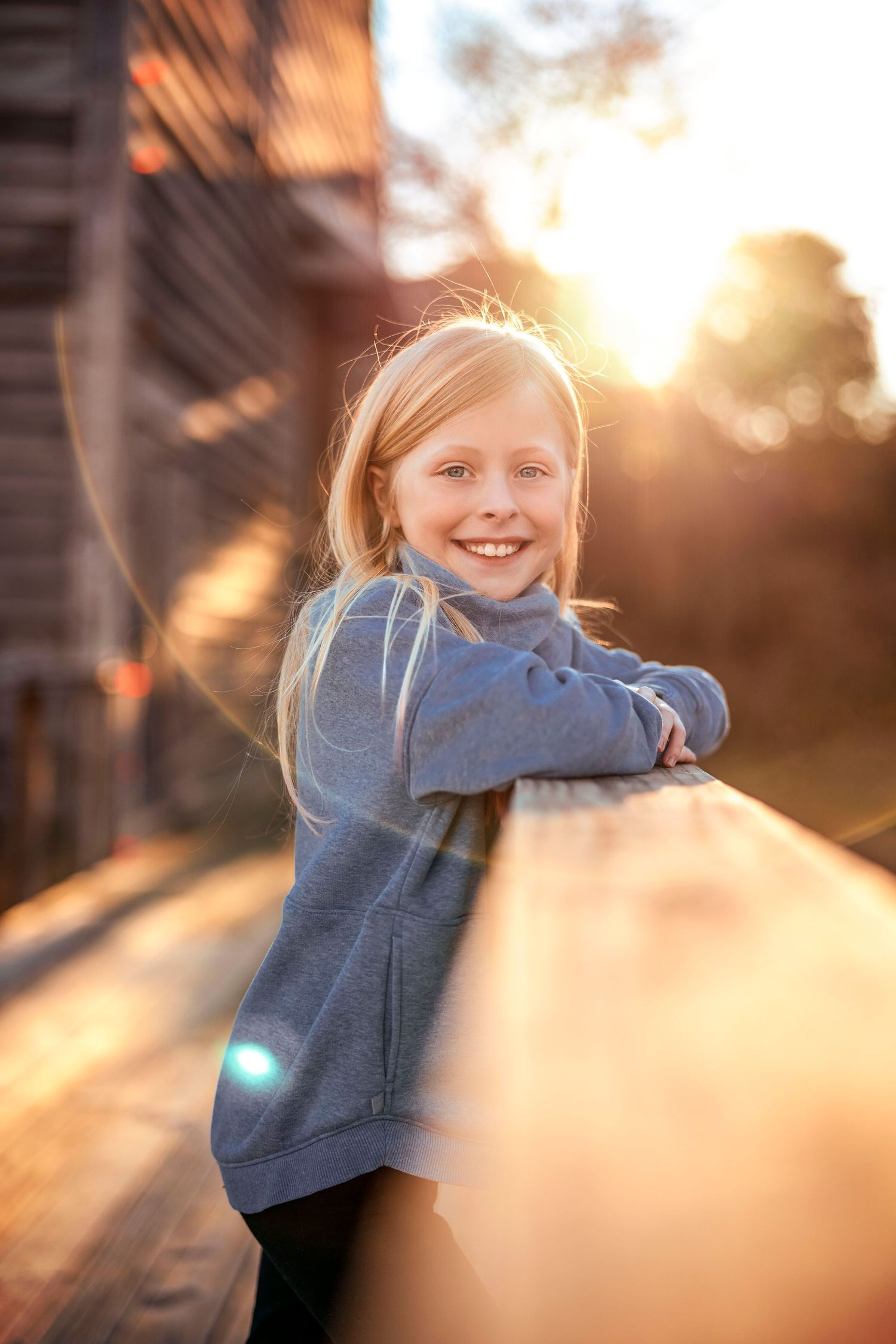 Playful movement sequence captured at sunset with golden bokeh effects.