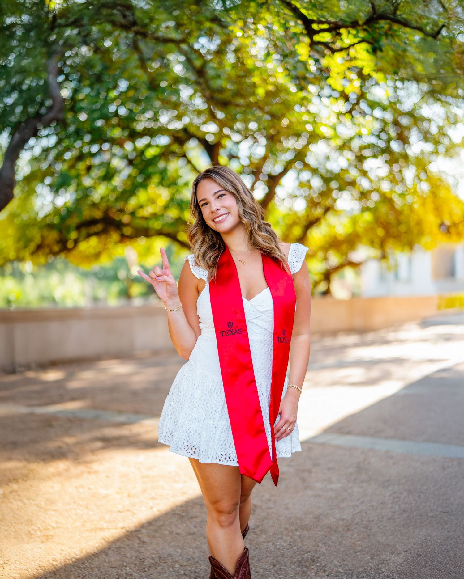 Outdoor graduation photography session with classic stone architecture backdrop.