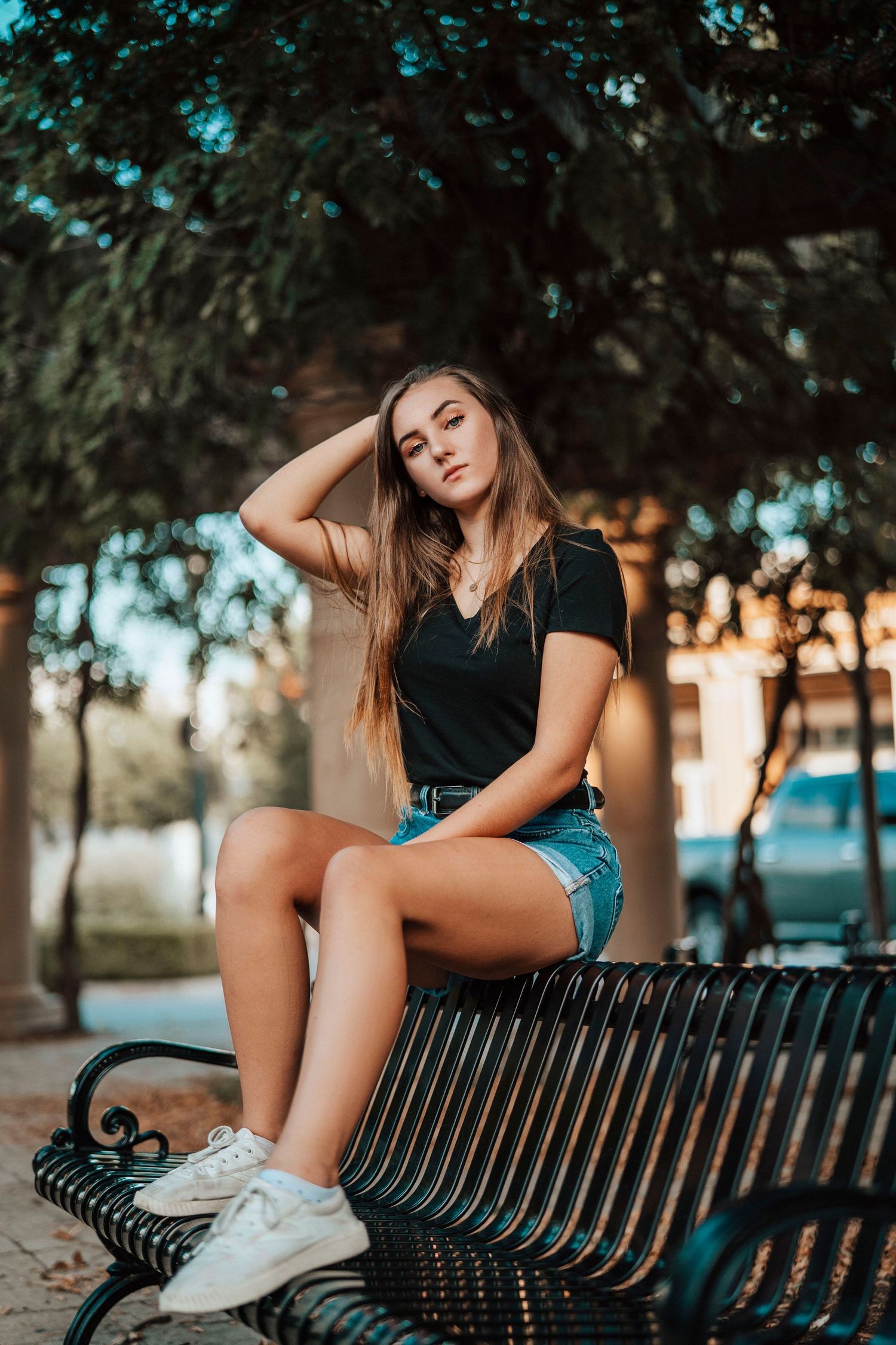 Relaxed outdoor photo on metal park bench at sunset.