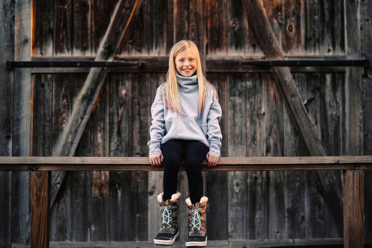 Creative portrait angles against dark wooden barn background show playful energy.