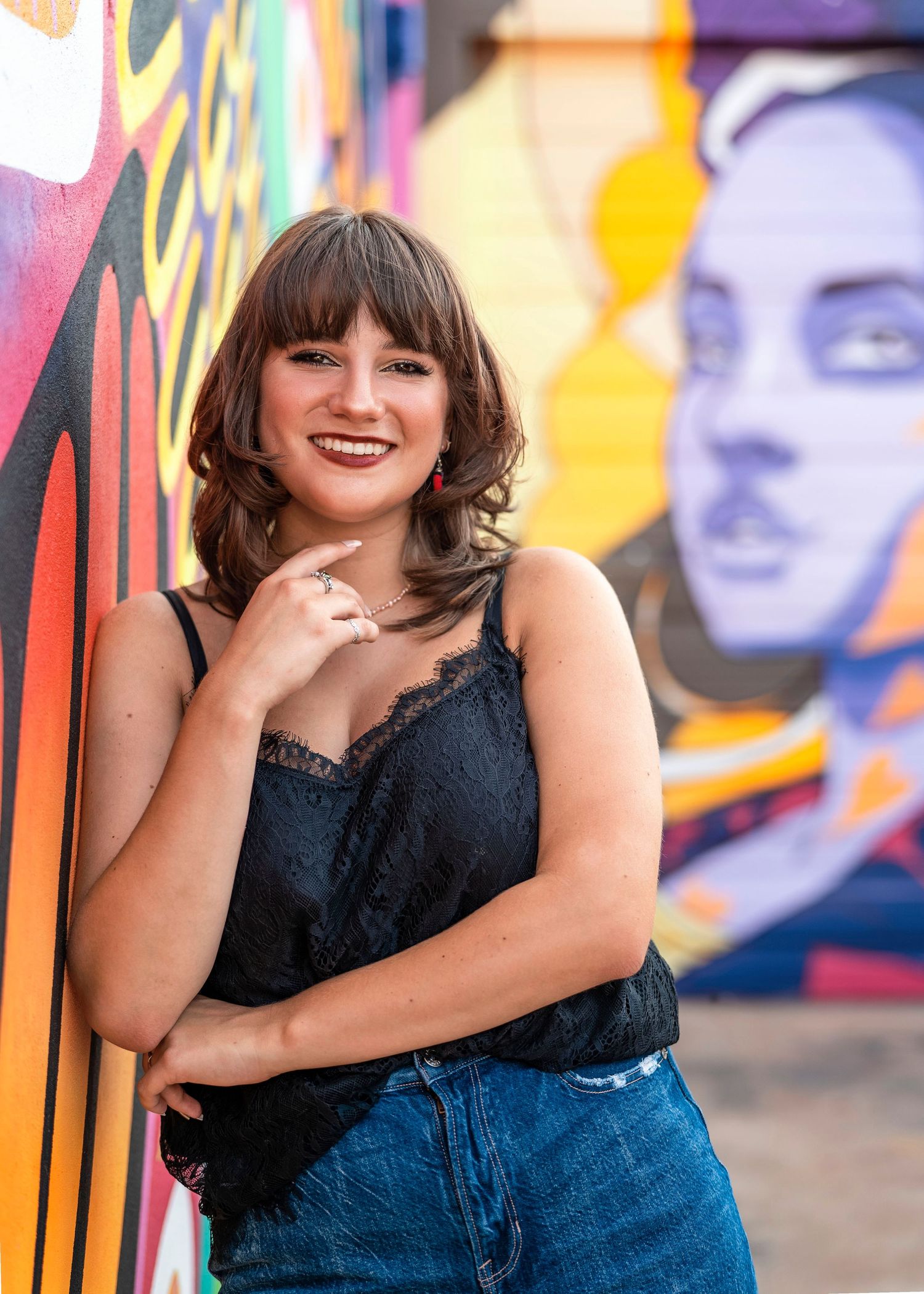 Fashion portraits against a bright graffiti wall showcase casual style and confident poses.