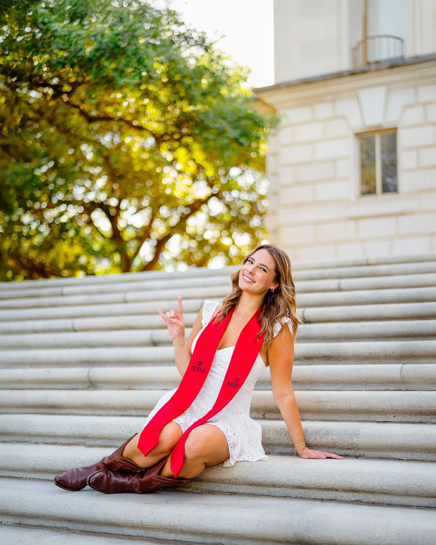 Celebratory graduation portraits on stone steps during sunset.