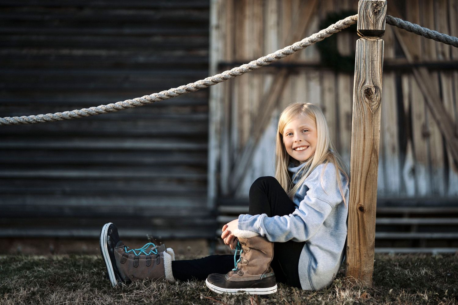 Dynamic outdoor portrait series with rustic wooden fence and natural lighting.