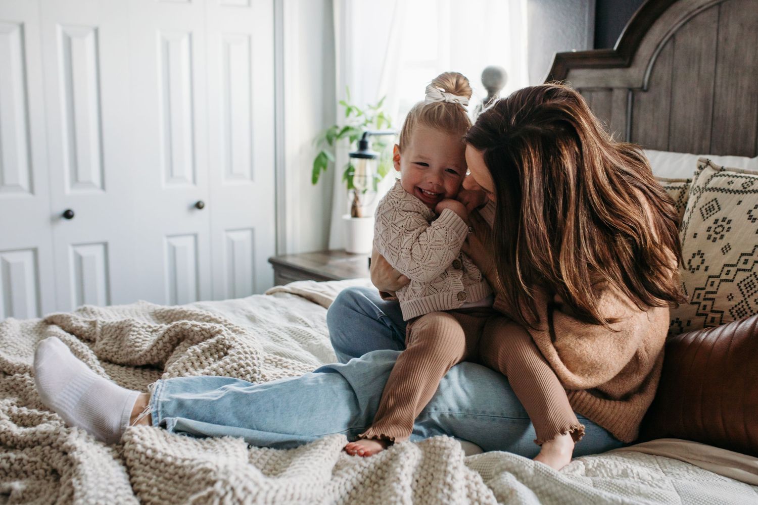 A series of cozy lifestyle photos showing people relaxing at home on couches with blankets and pillows -in-home lifestyle family photos