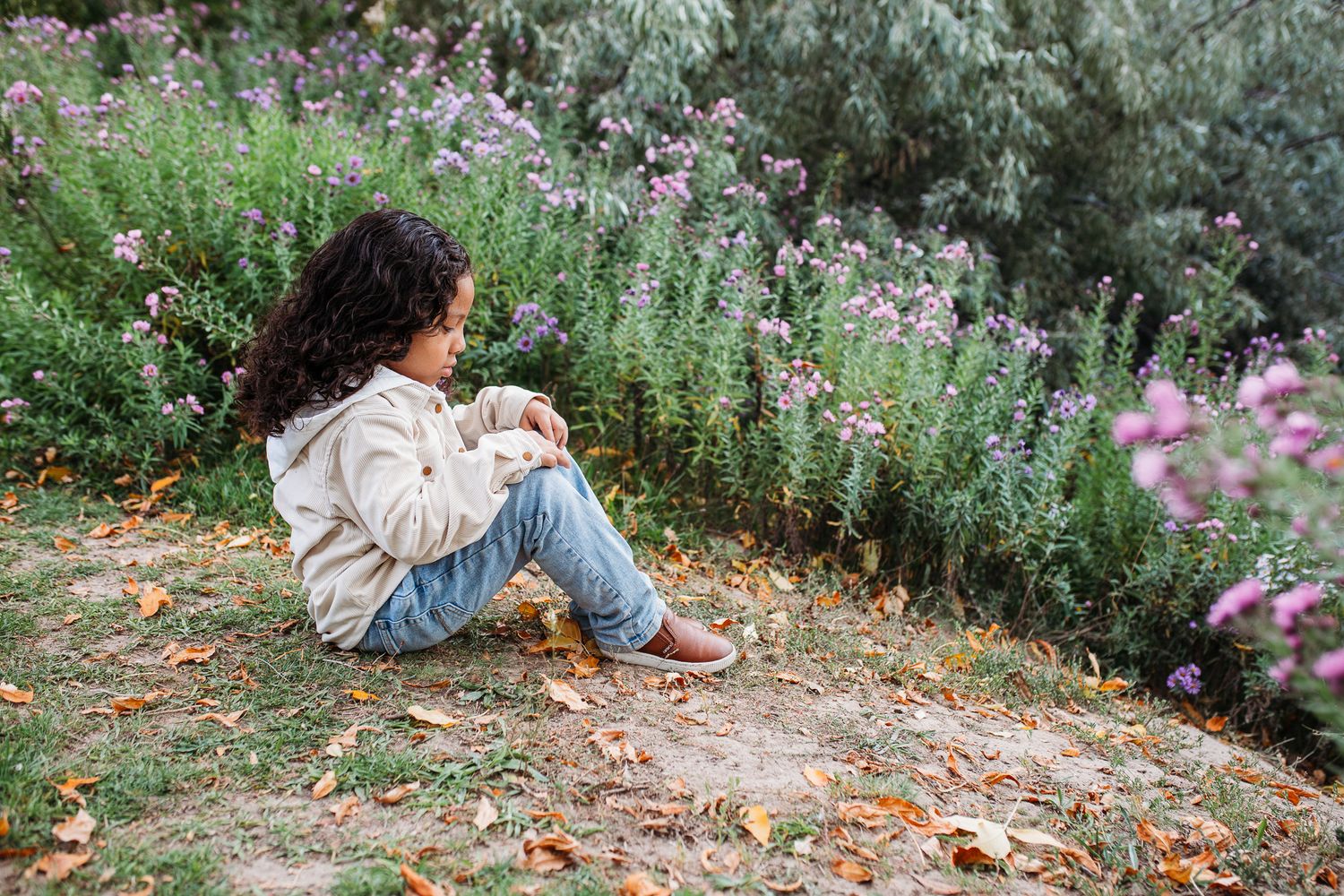 A series of dreamy photos taken in a lush garden setting with soft pink flowers and natural greenery - milestone photos Eagel Idaho
