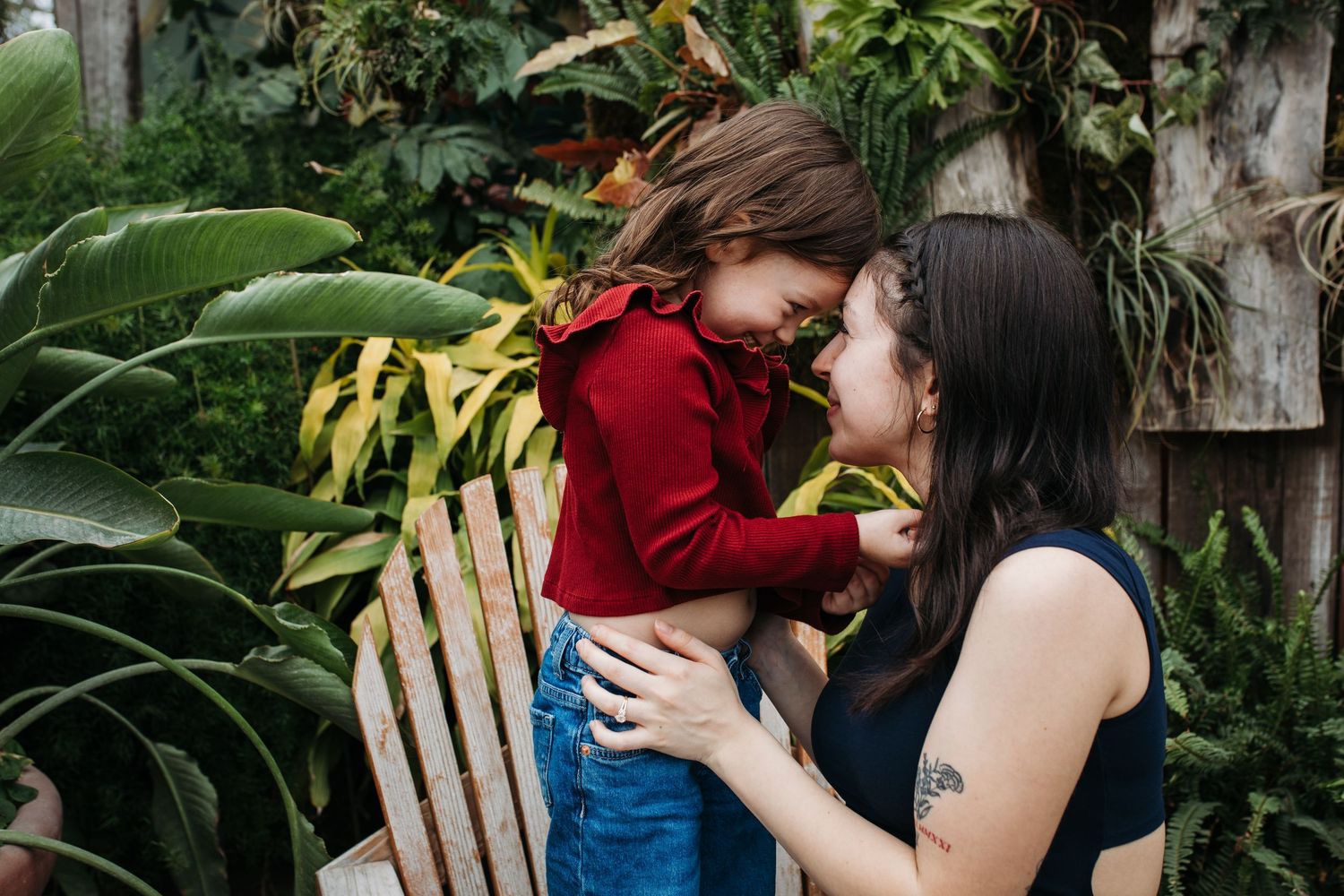 Mom and daughter sharing a forehead-to-forehead moment during a greenhouse session in Boise, Idaho.