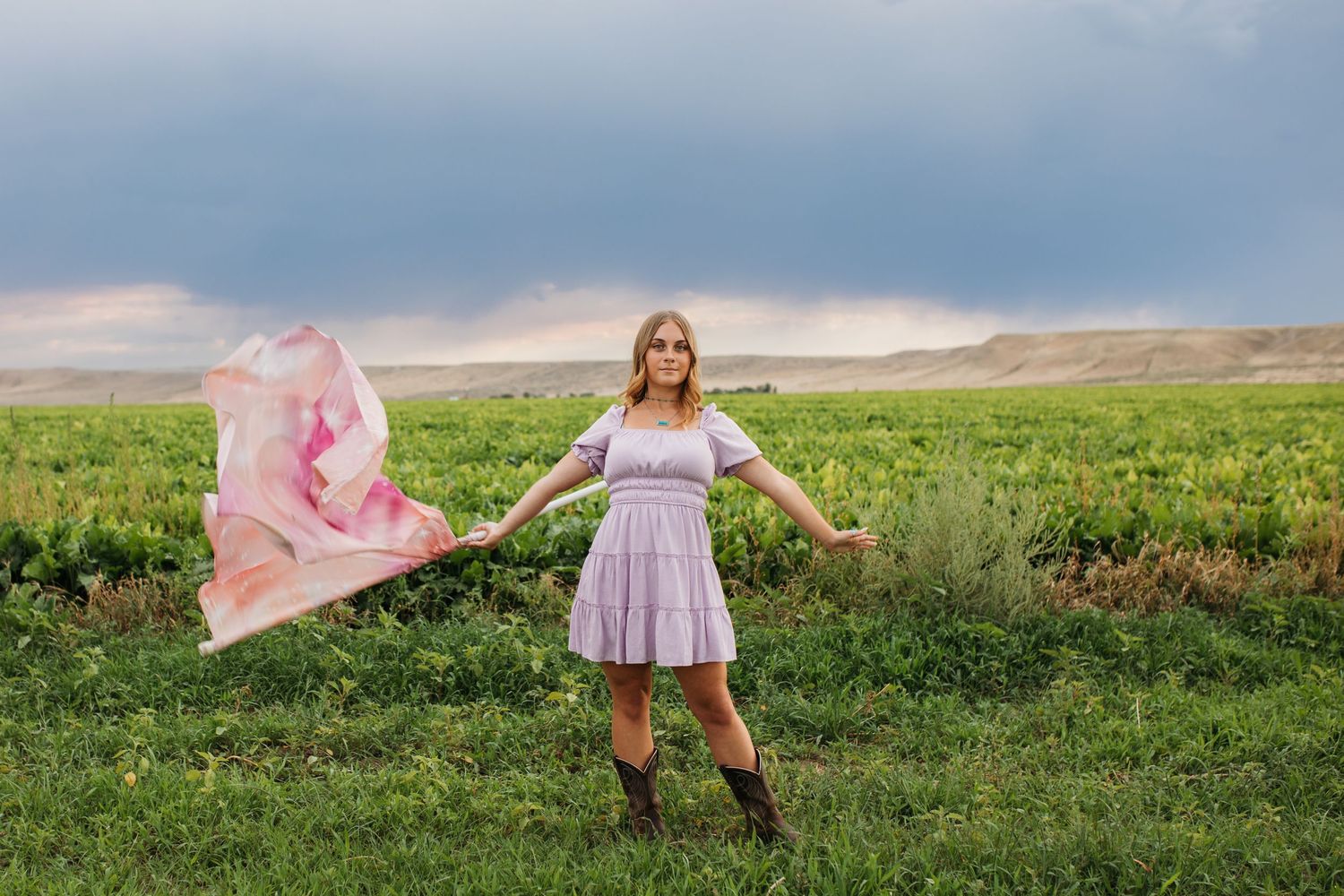 Boise senior color guard portrait in field with flowing flag