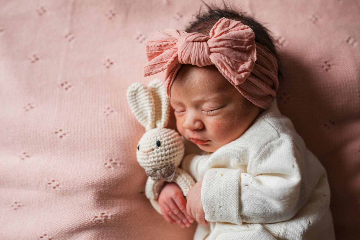 Sleeping newborn baby girl cuddling a stuffed bunny during a Fresh 48 hospital newborn session in Boise, Idaho