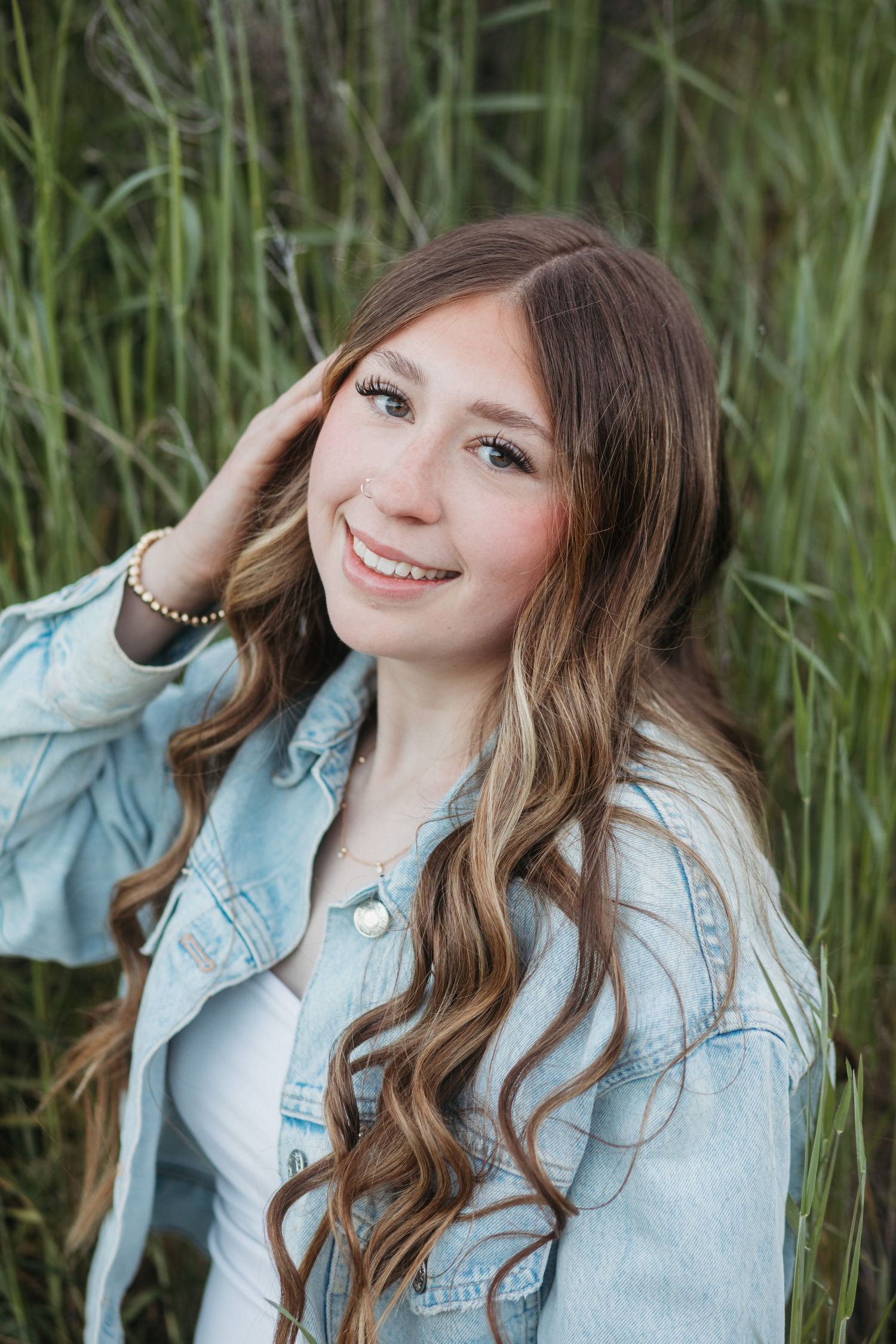 Senior girl in denim jacket posing outdoors during Boise senior photo session