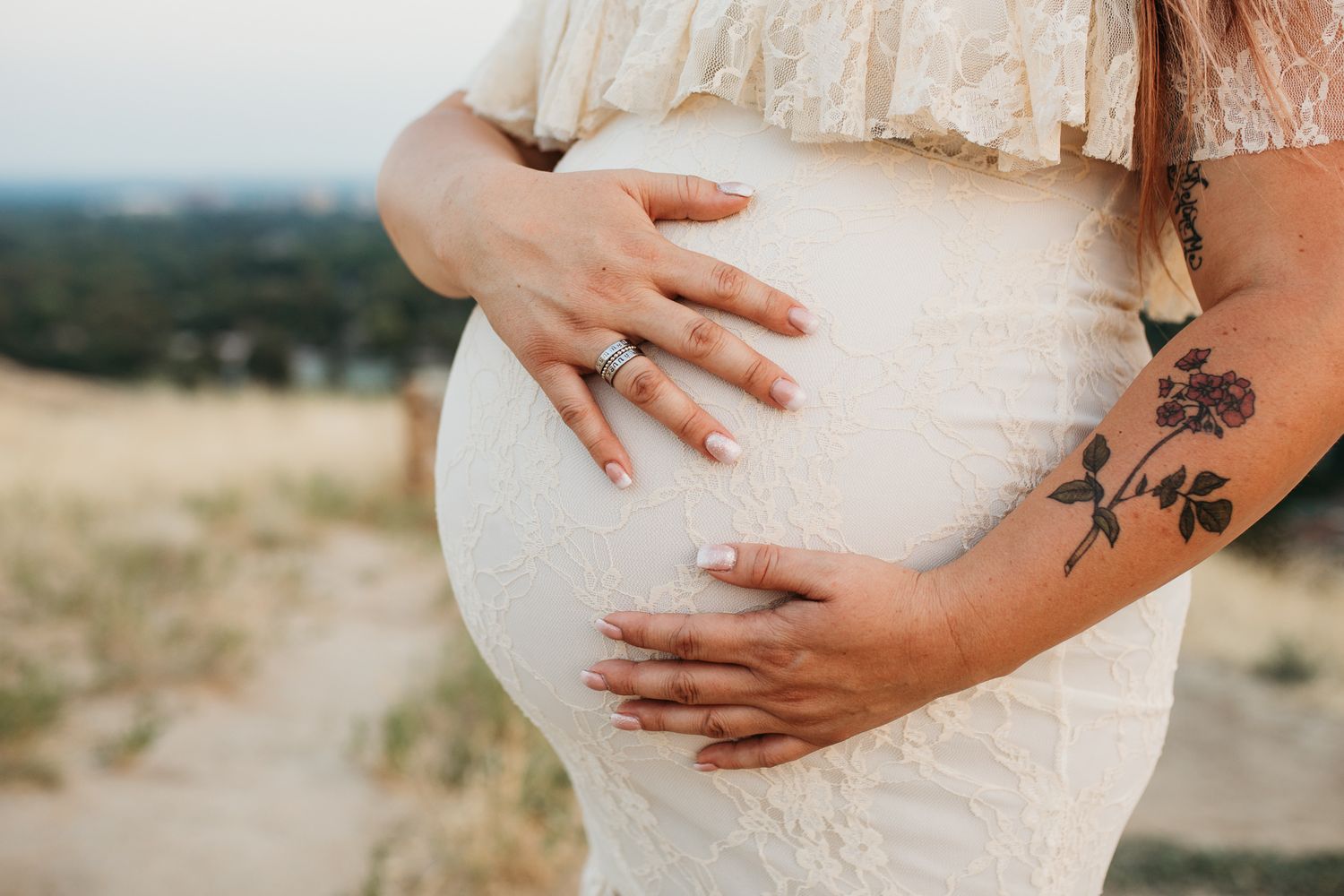 A series of maternity photos showing hands gently cradling a pregnant belly in a white lace dress outdoors - Maternity session in Boise