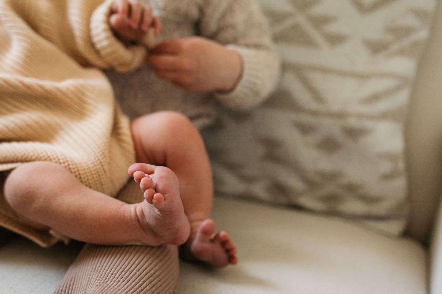 Close-up of newborn baby feet and tiny hands during an in-home lifestyle newborn session in Boise, Idaho.