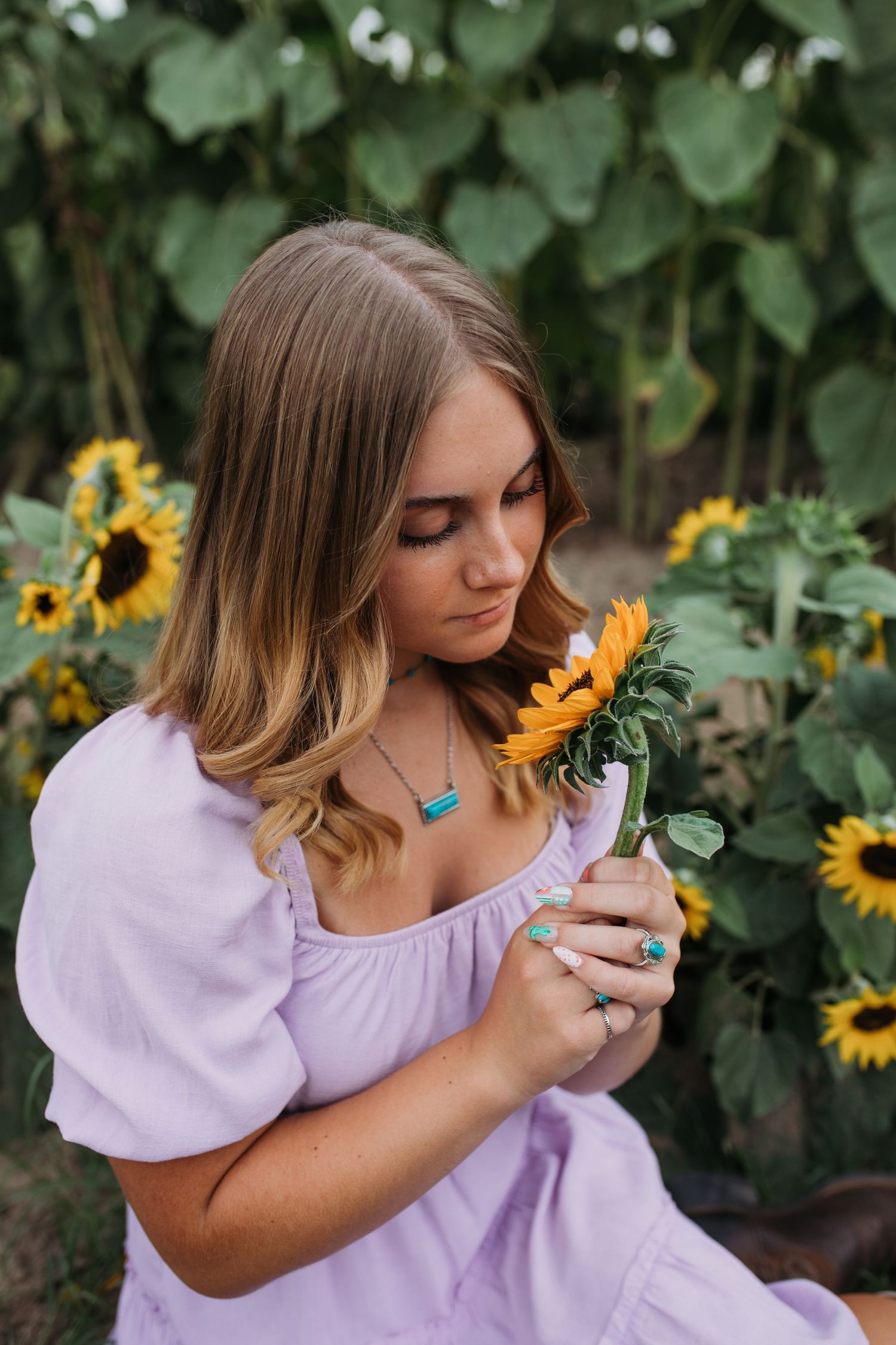 Boise summer senior photos of high school senior in sunflower field