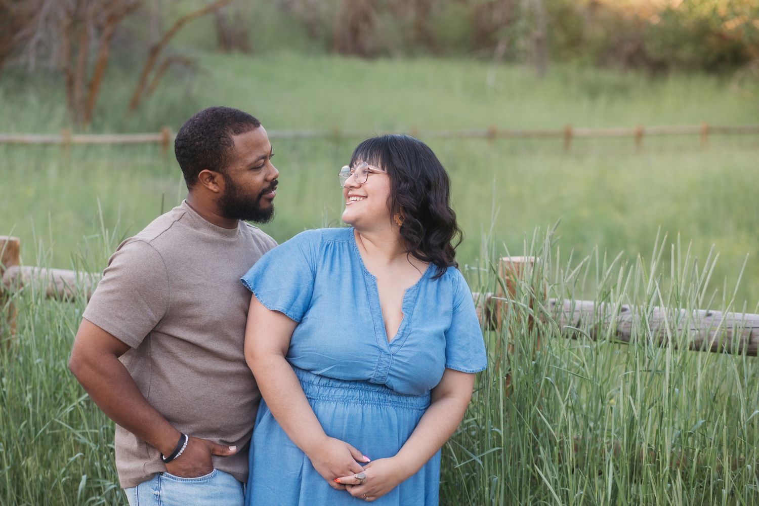 Couple sharing a candid moment during a spring family photography session at Camel’s Back Park in Boise.