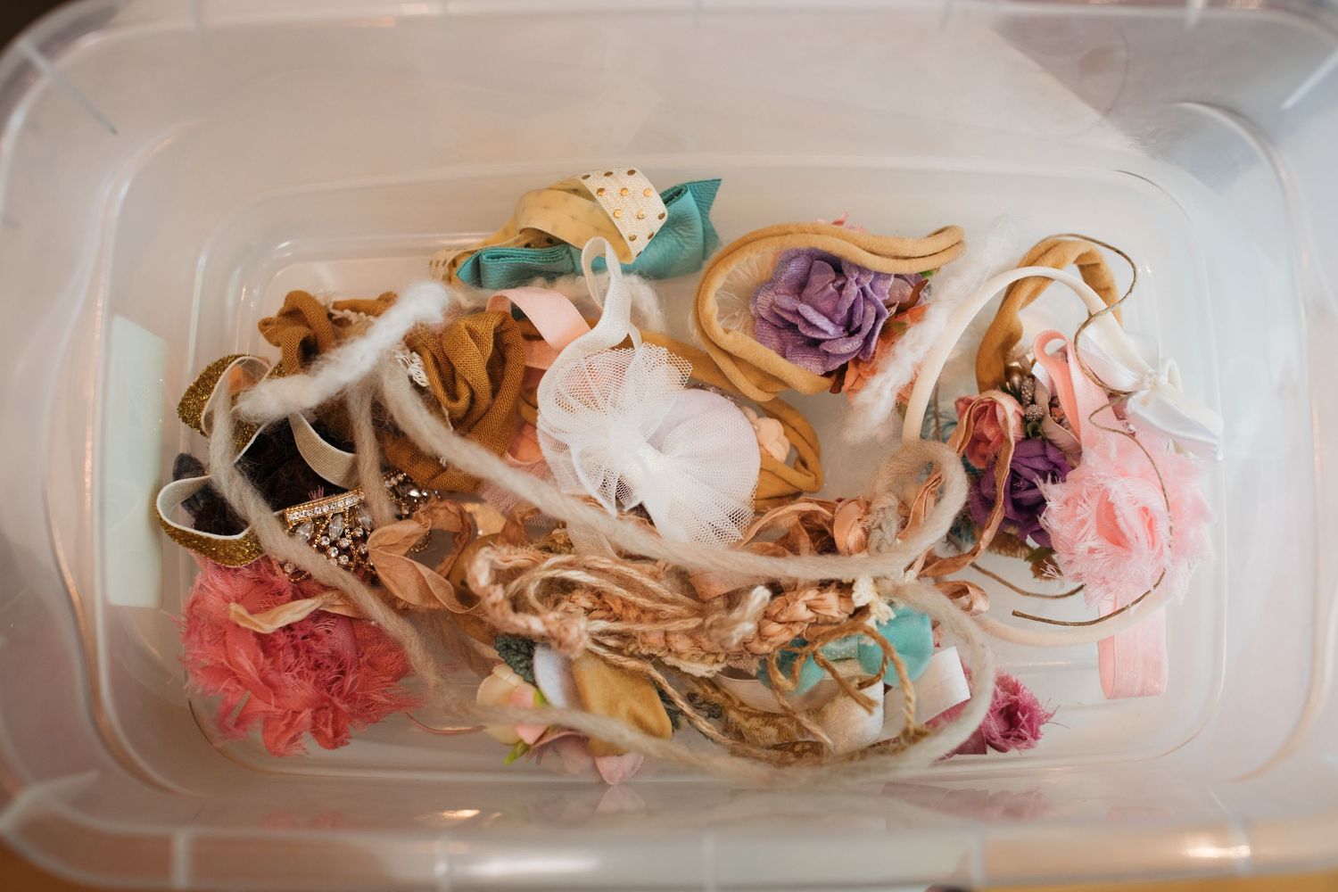 Collection of newborn headbands and delicate photography accessories for baby portraits.