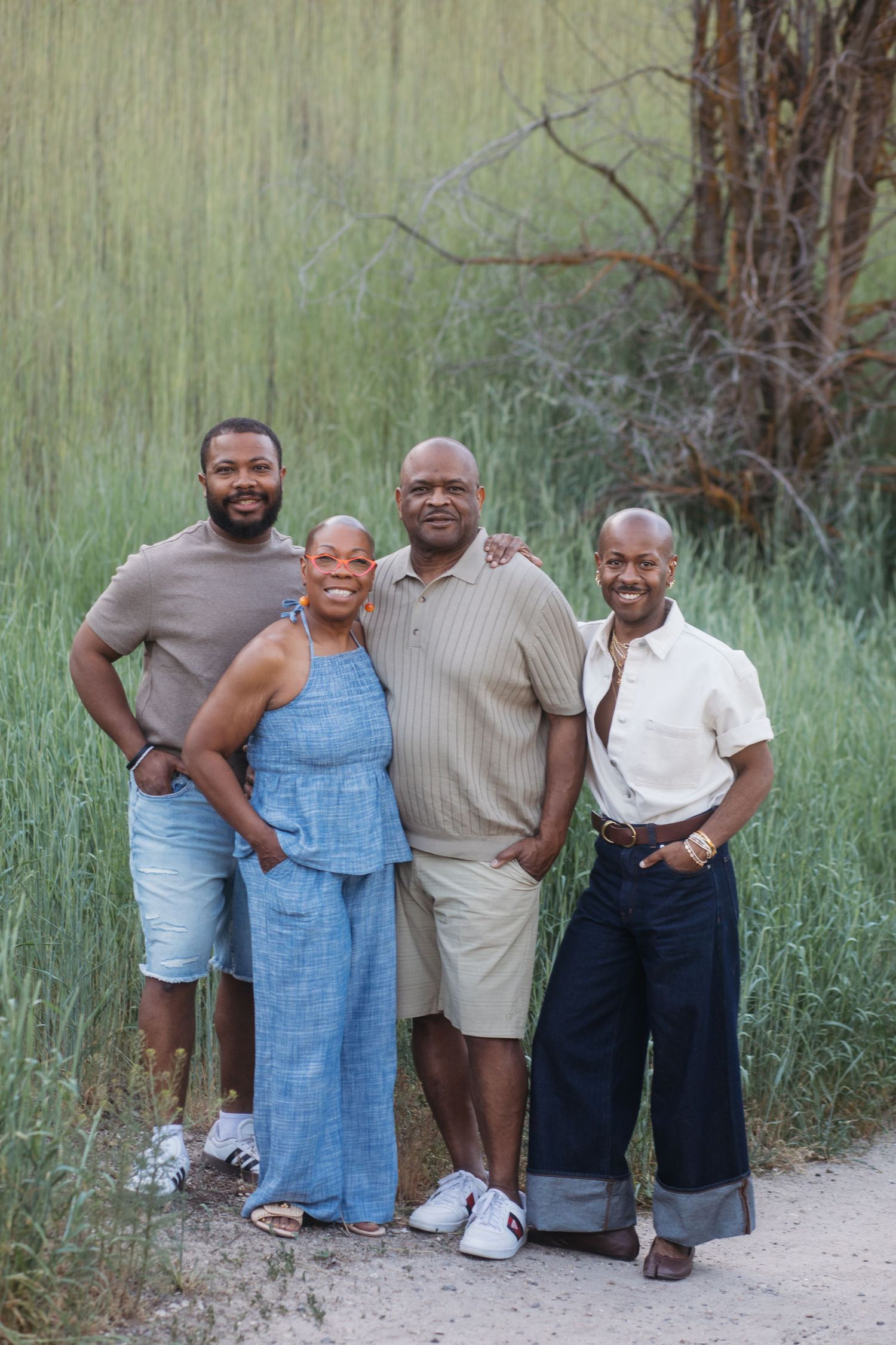 Adult son posing with parents during an extended family photography session at Camel’s Back Park in Boise.
