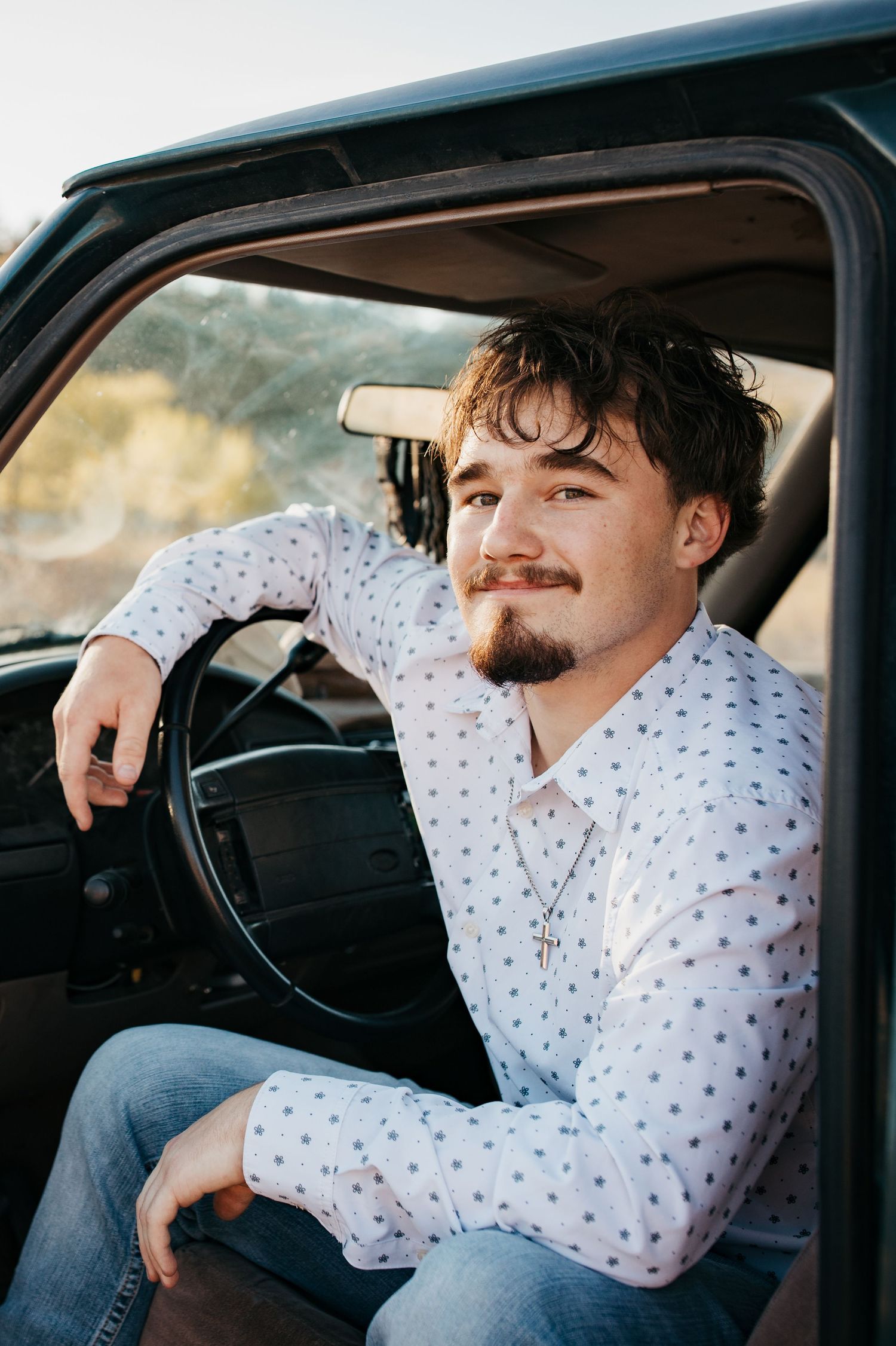 Close up senior portrait of high school boy sitting in truck during Boise Idaho senior photo session