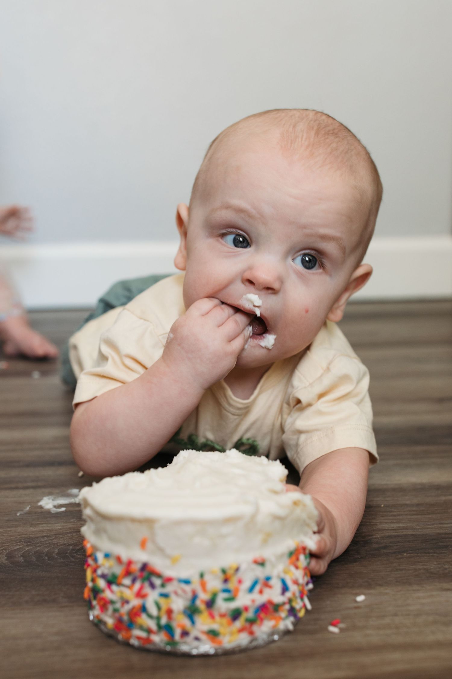 One year old boy eating birthday cake during a twin cake smash session in Kuna Idaho.