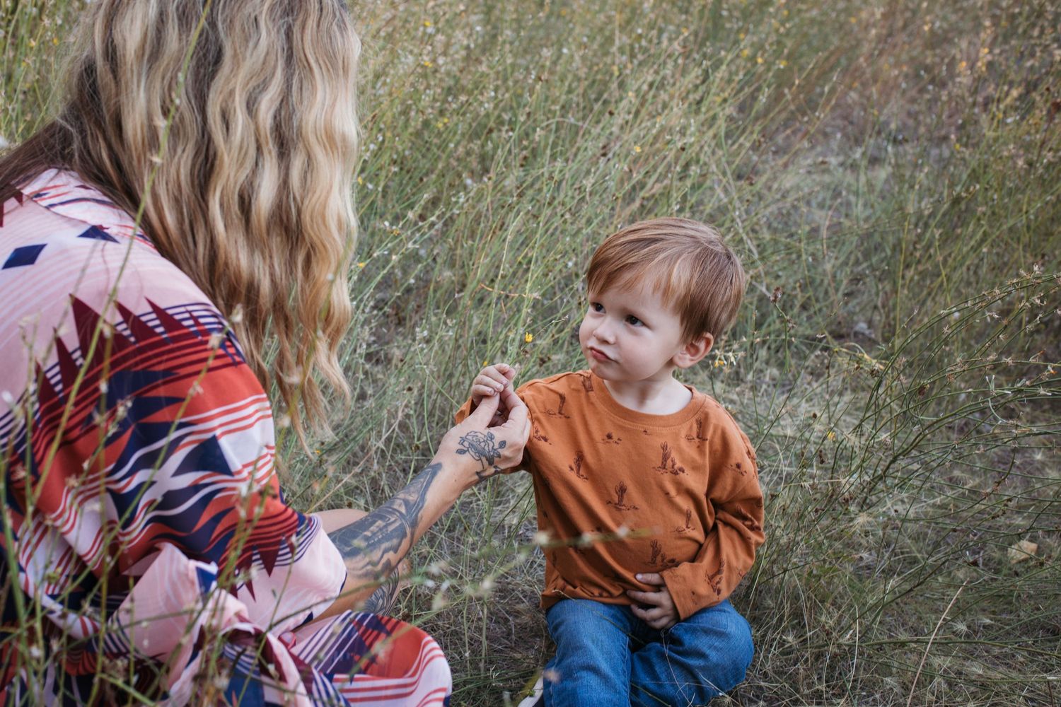 Parent interacting with toddler during a guided outdoor lifestyle family photo session in Boise, Idaho