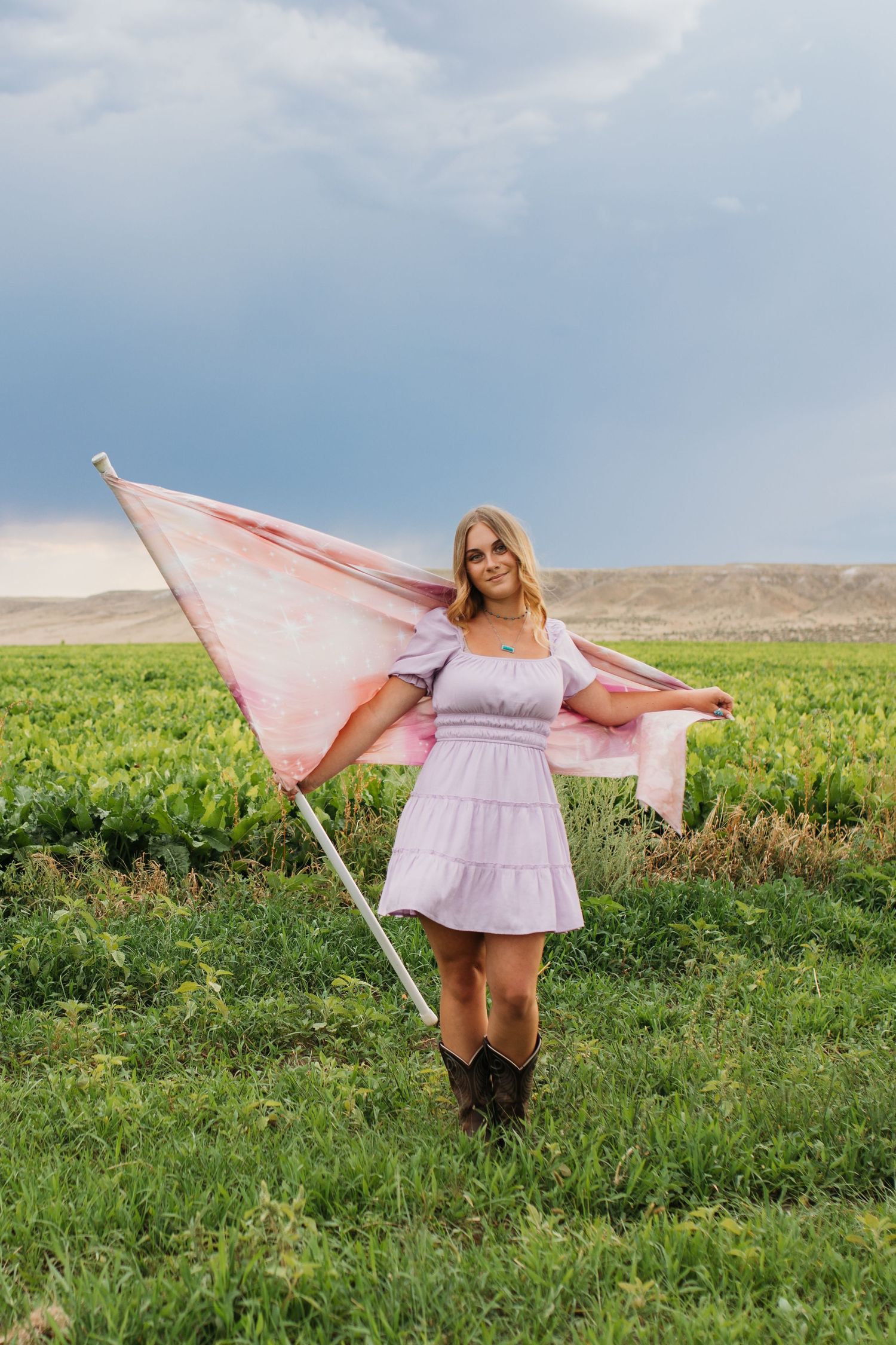 Senior color guard photos in Idaho field with flag