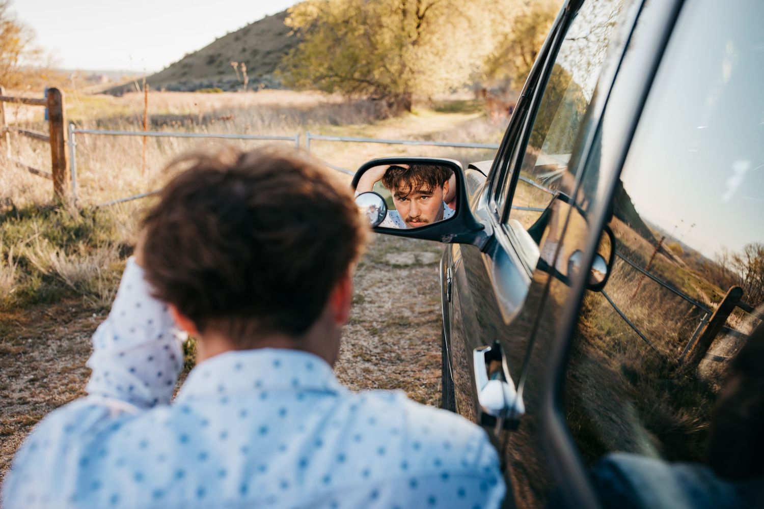 Creative senior photo of high school boy reflected in truck side mirror during Boise Idaho senior session