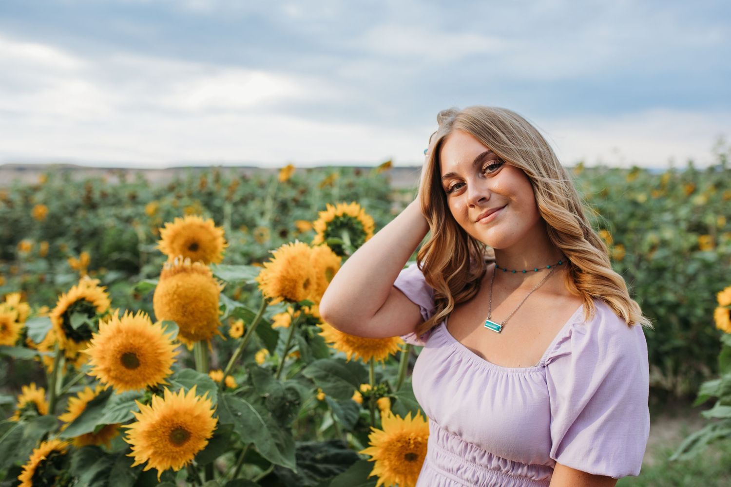 Outdoor headshot of teen girl in sunflower field with natural light, Boise Idaho photographer