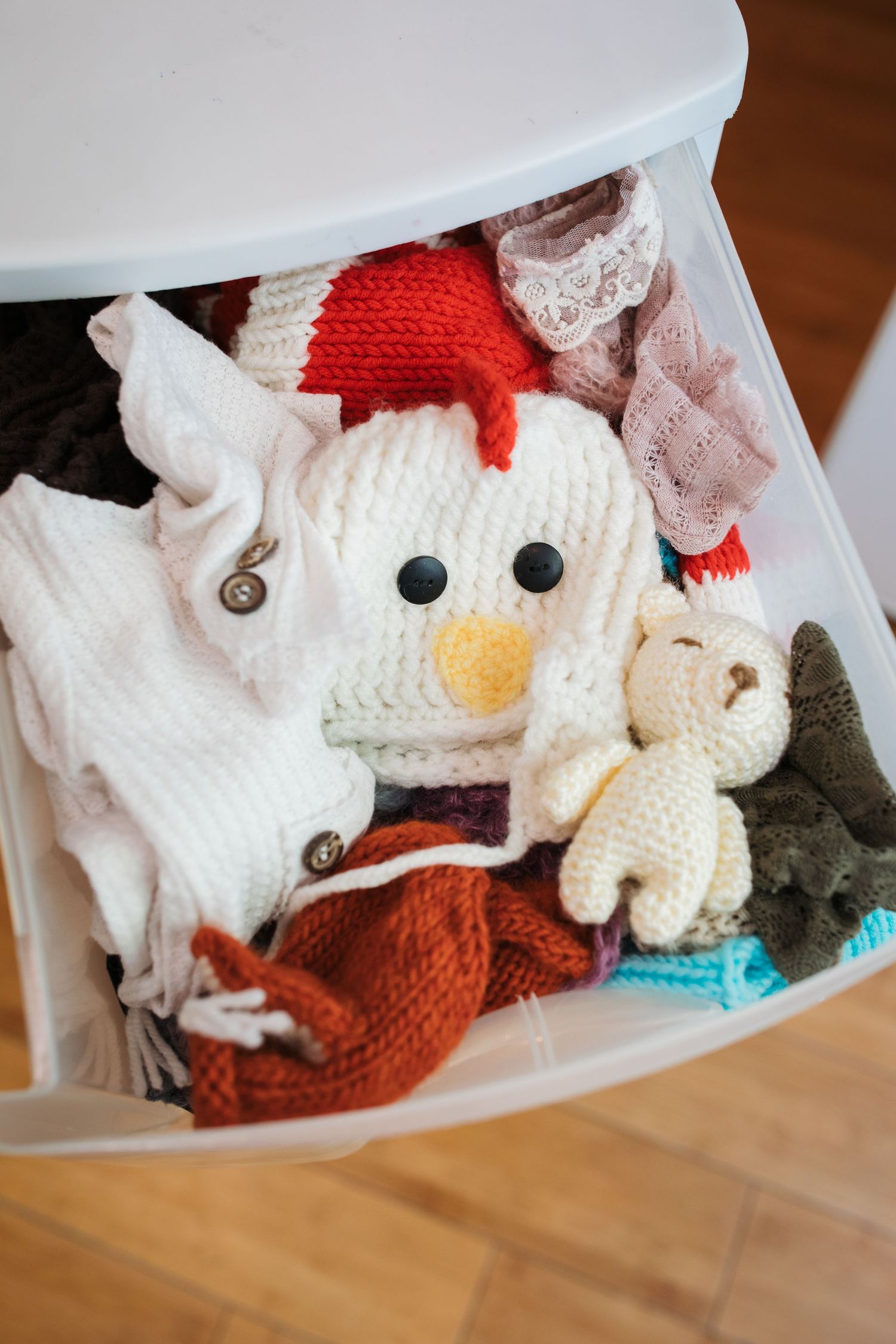 Newborn hats, bonnets, and photography props organized for studio sessions.