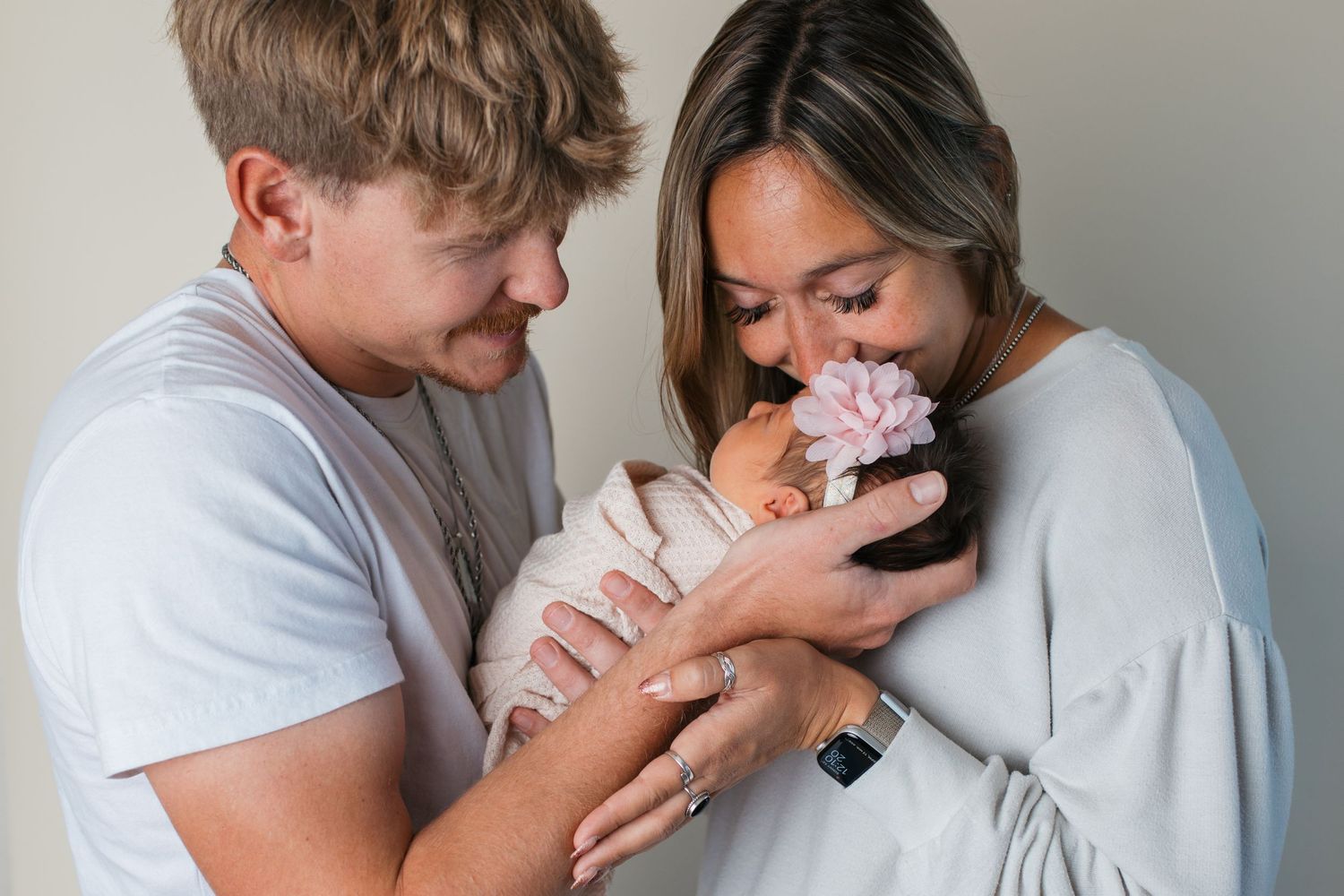 Caldwell studio newborn session with parents cuddling their baby girl in soft natural light