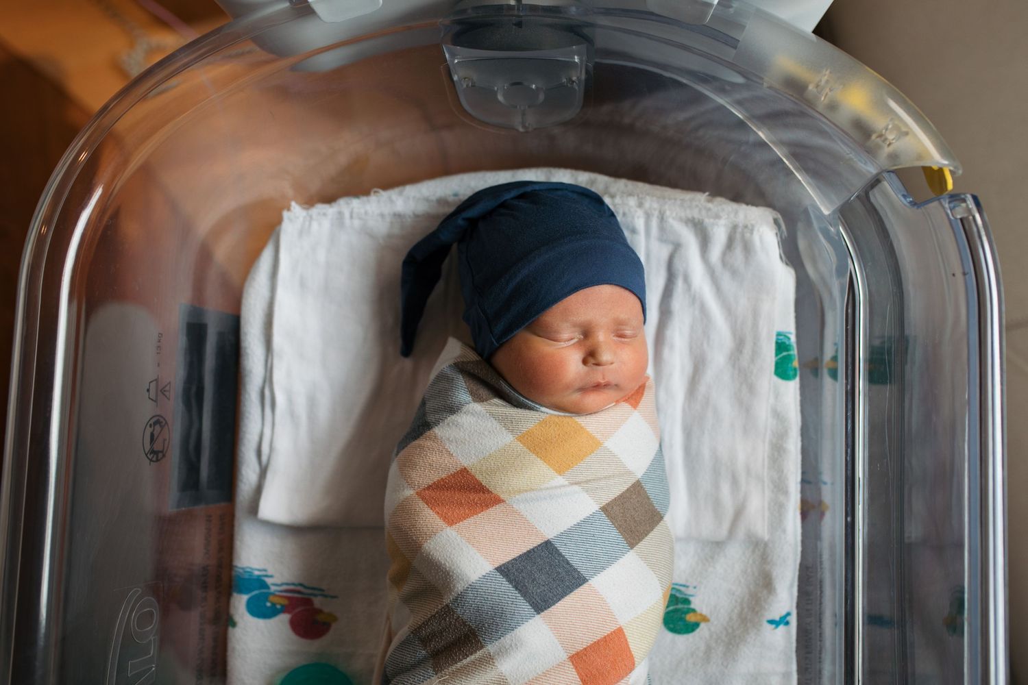 Fresh 48 hospital newborn session at St. Luke’s in Boise, Idaho with a swaddled newborn baby resting in a hospital bassinet.
