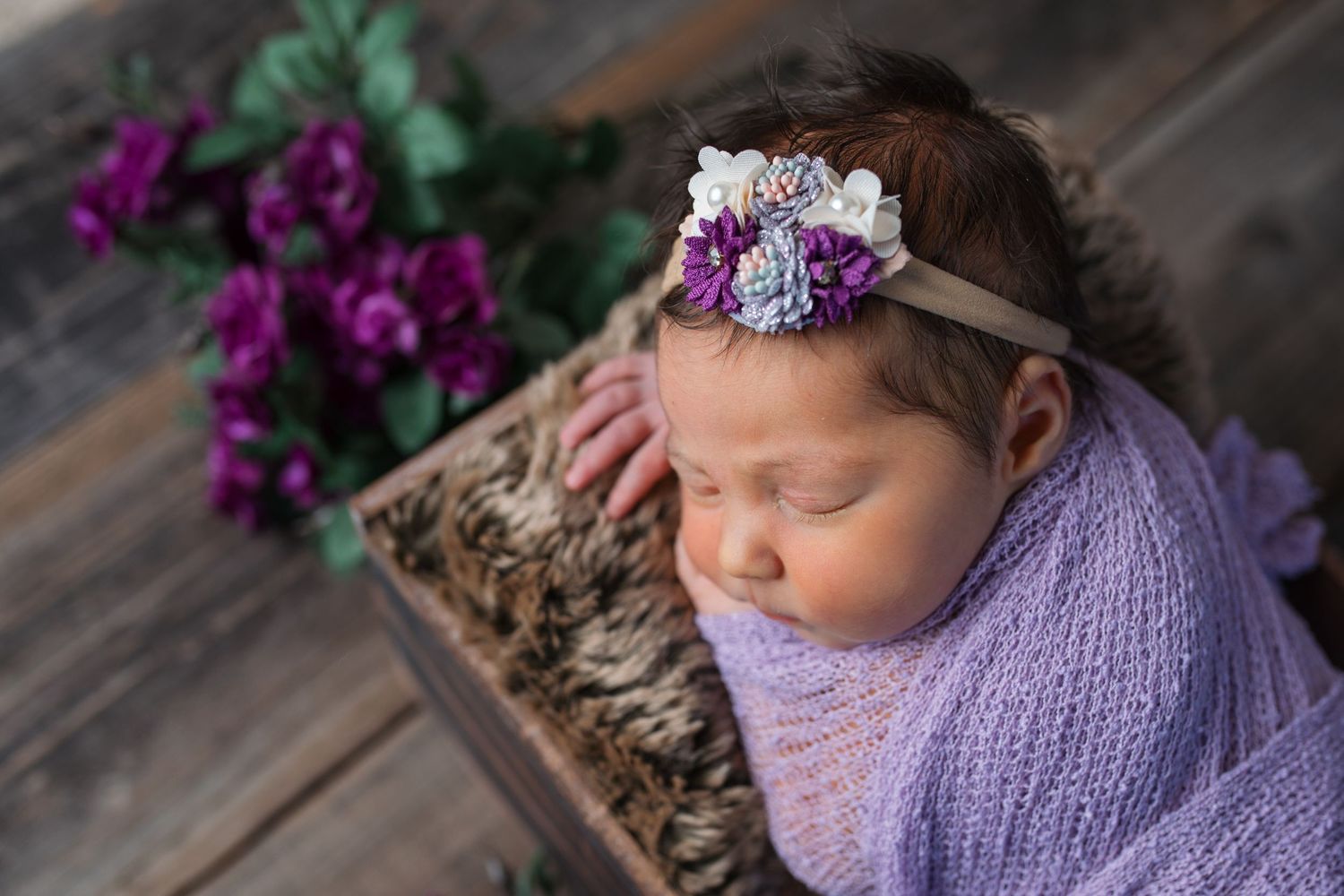 Wrapped newborn baby in a simple prop setup during a newborn mini session in Nampa, Idaho