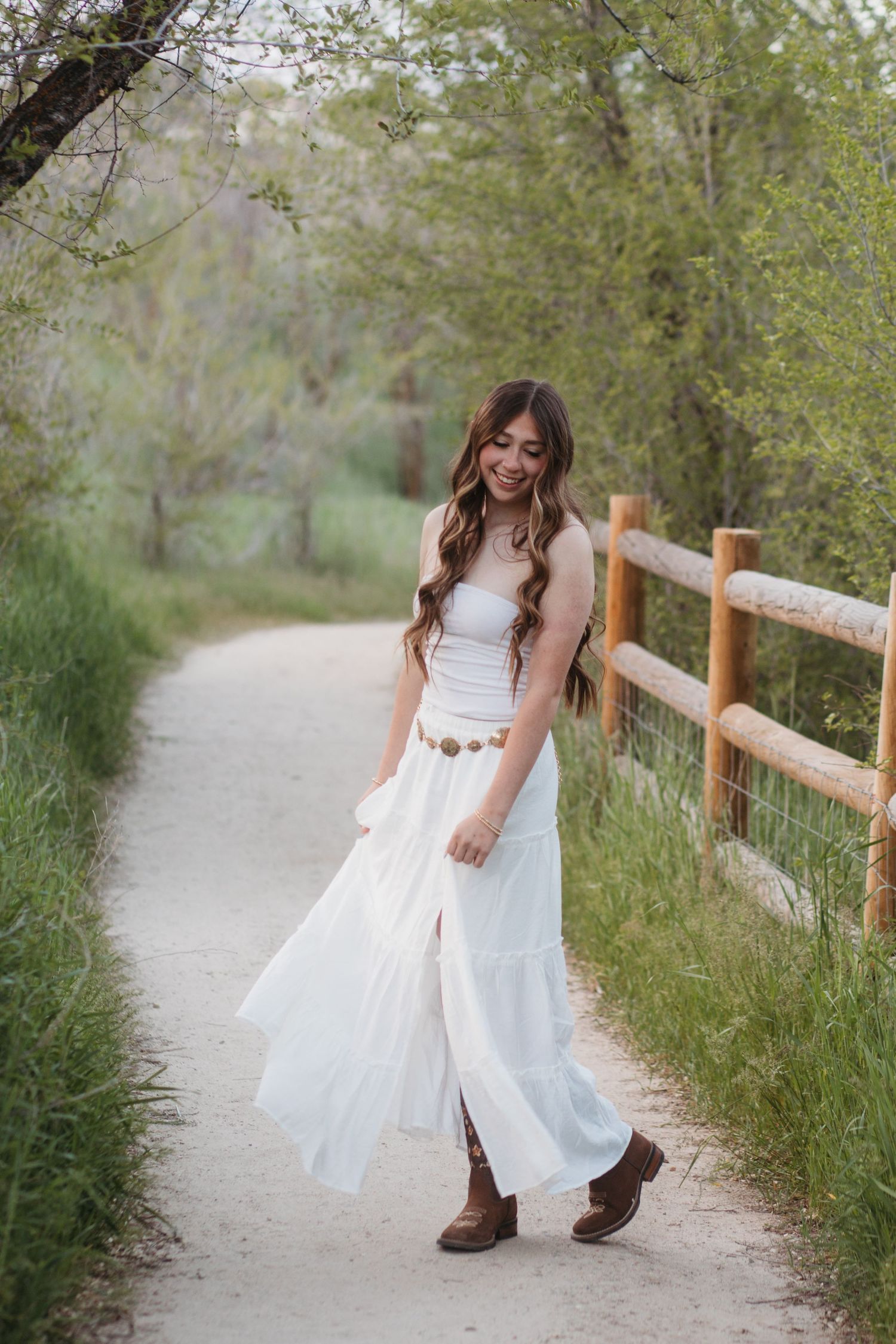 High school senior walking on path in flowing dress during Boise senior photo session