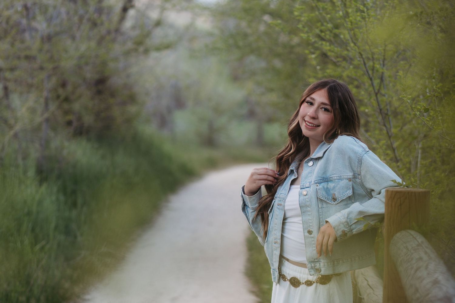High school senior girl smiling in soft golden light during Boise senior photo session