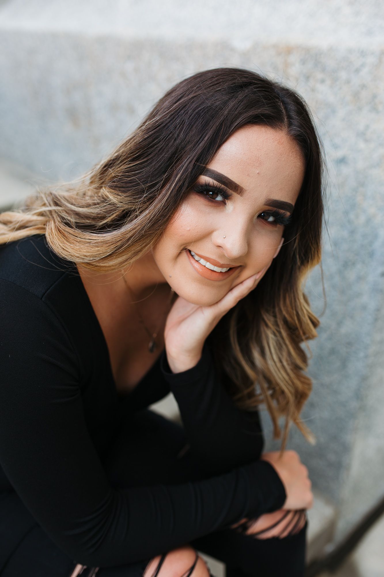 A series of portrait photos showing someone with ombre hair wearing black against a textured gray background - Senior photos Nampa Idaho