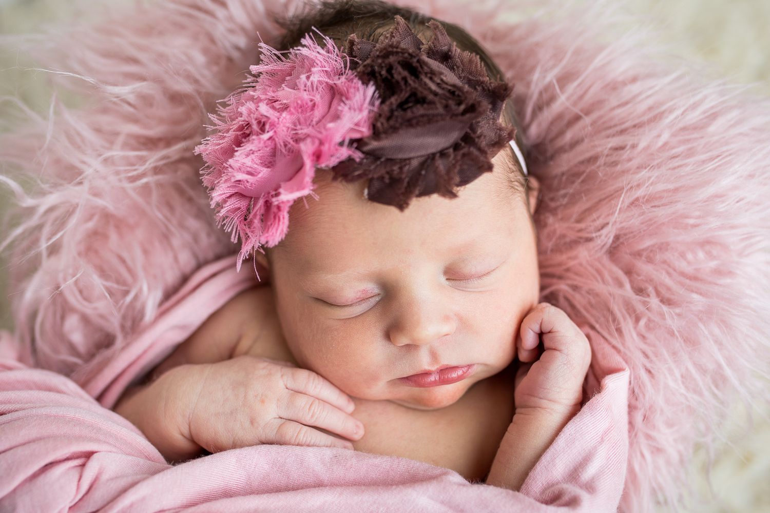 soft pink newborn photography portraits showing sleeping baby details against fluffy pink background -studio newborn photography Nampa Idaho