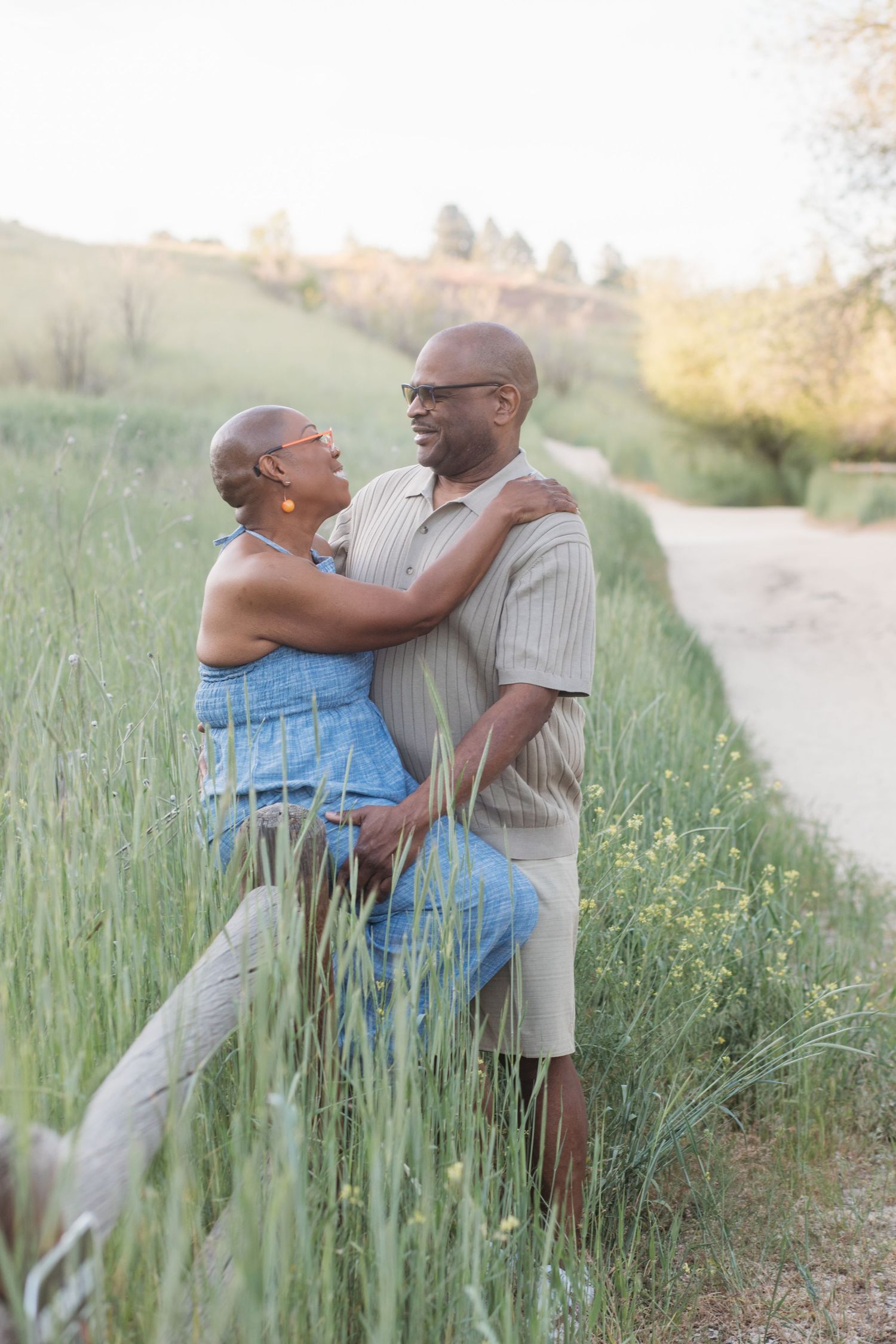 Couple sharing a candid moment in the Boise foothills during an outdoor family photography session at Camel’s Back Park.