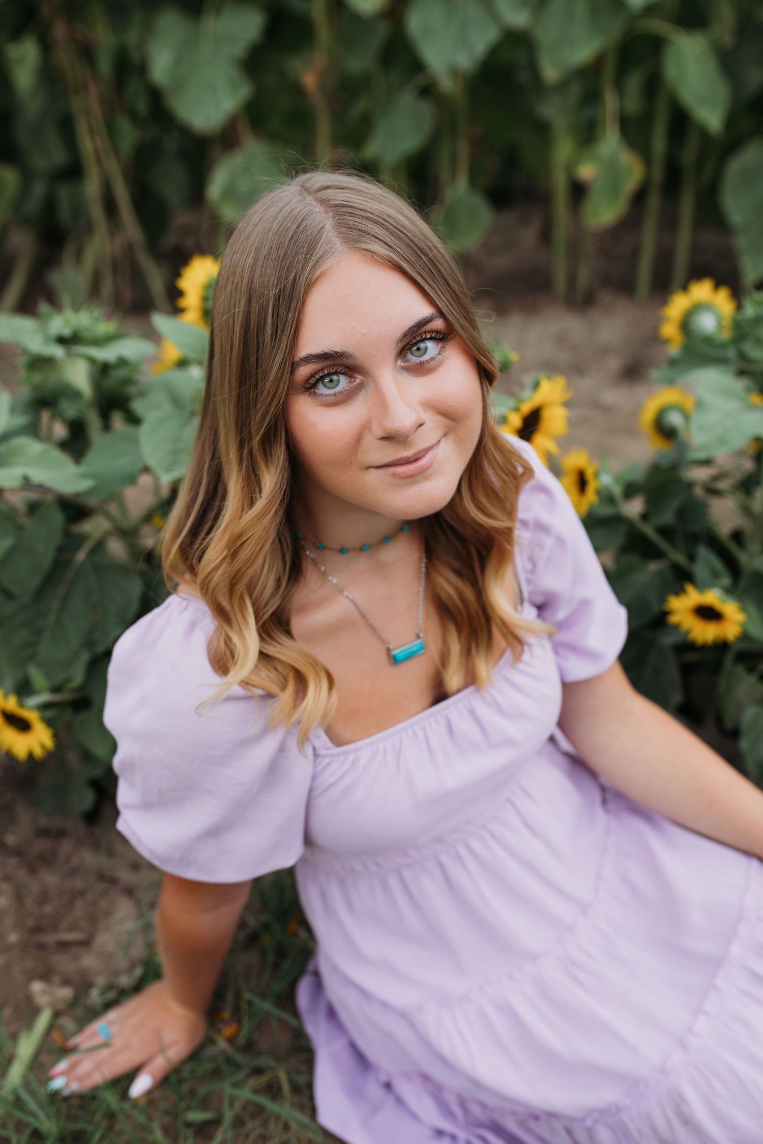 Treasure Valley senior portrait close up in sunflower field during summer session