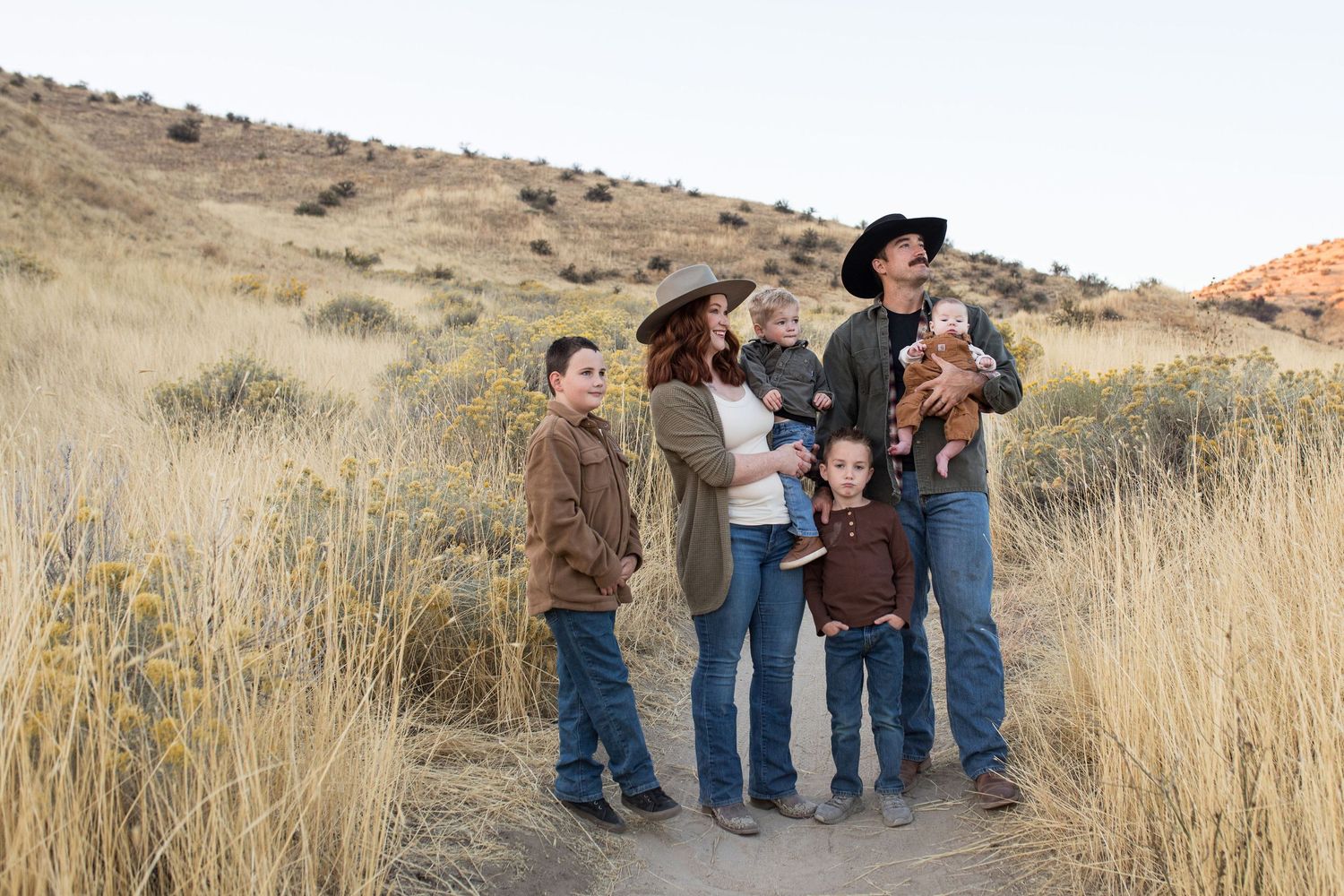 Family of six standing together in the Boise foothills during a fall family photography session with Sara Elizabeth Photography.