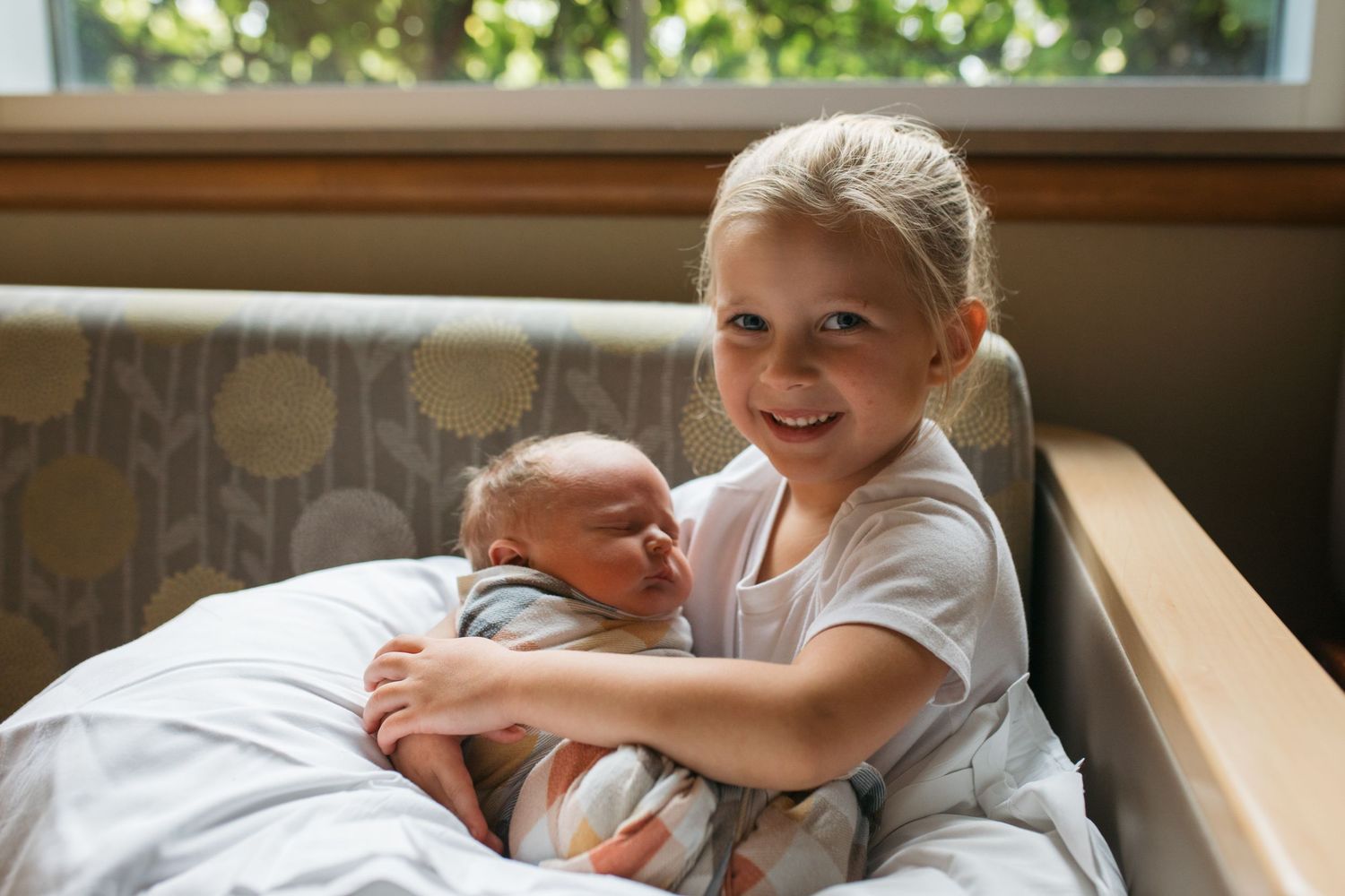 an older sibling holding a new baby in the hospital Fresh 48 session by Sara Elizabeth Photography Boise Idaho
