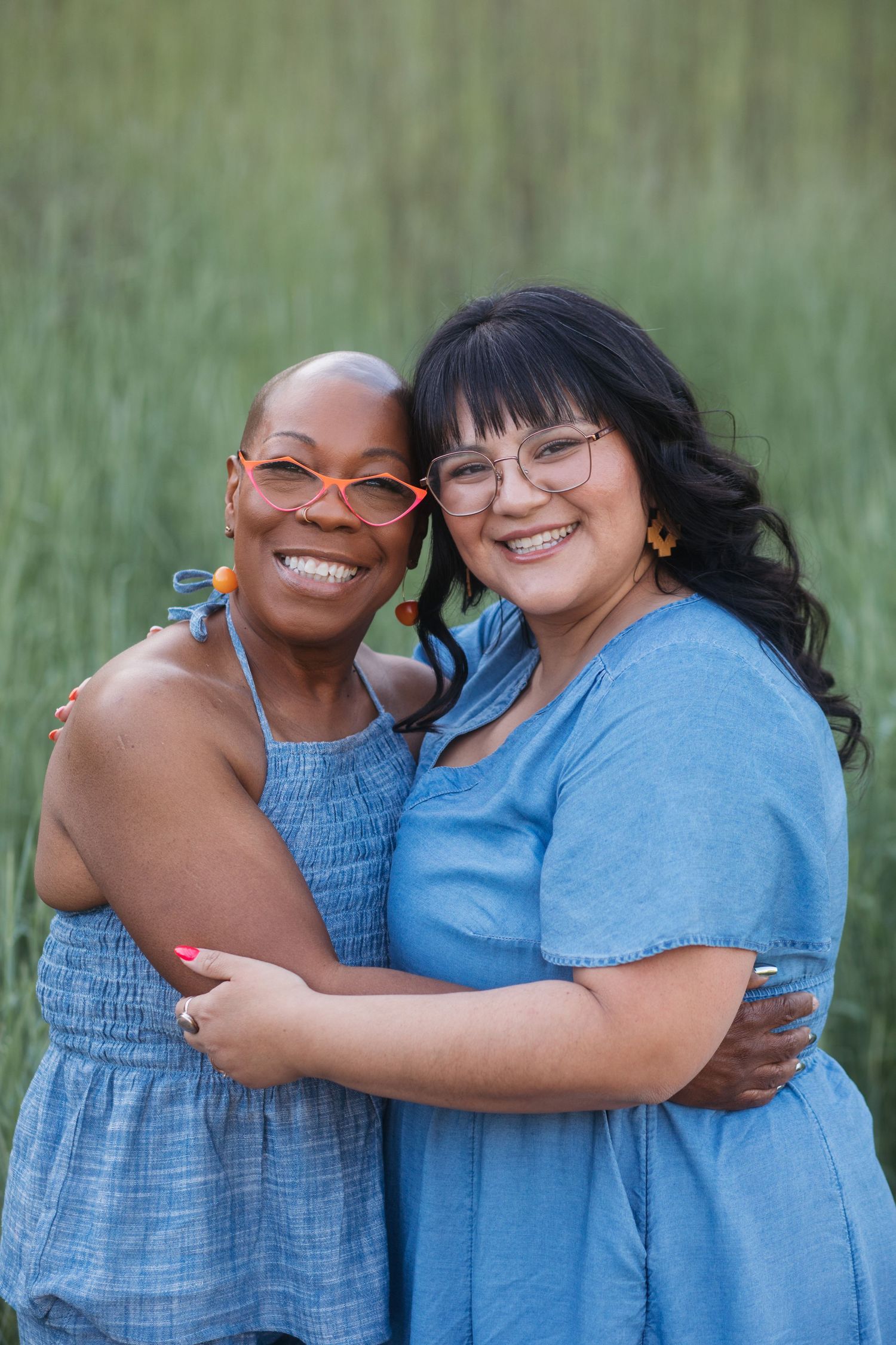 Mother-in-law and daughter-in-law embracing during a spring family photography session at Camel’s Back Park.