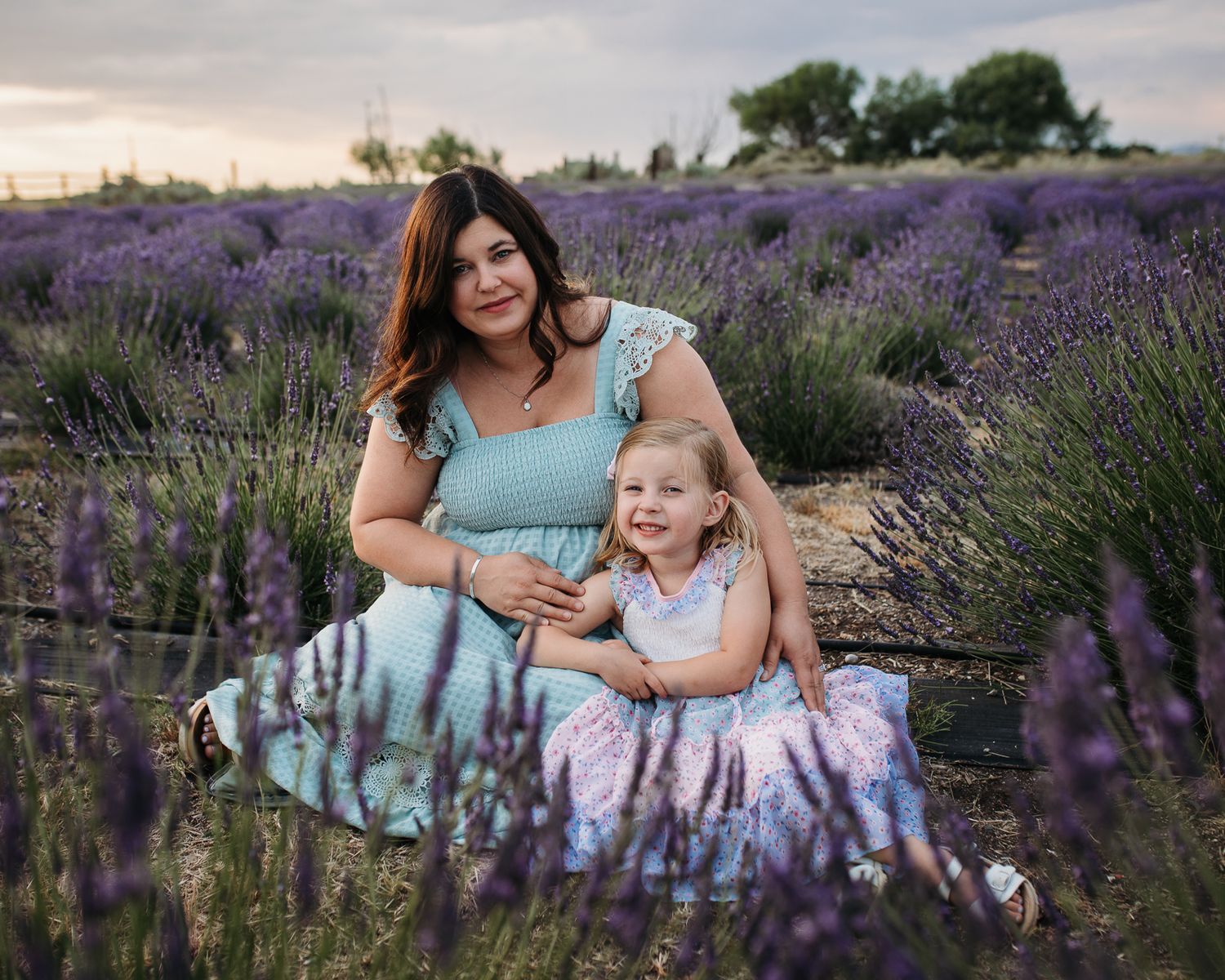 people enjoying a vibrant purple lavender field on a sunny summer day - Maternity session in Boise, Idaho
