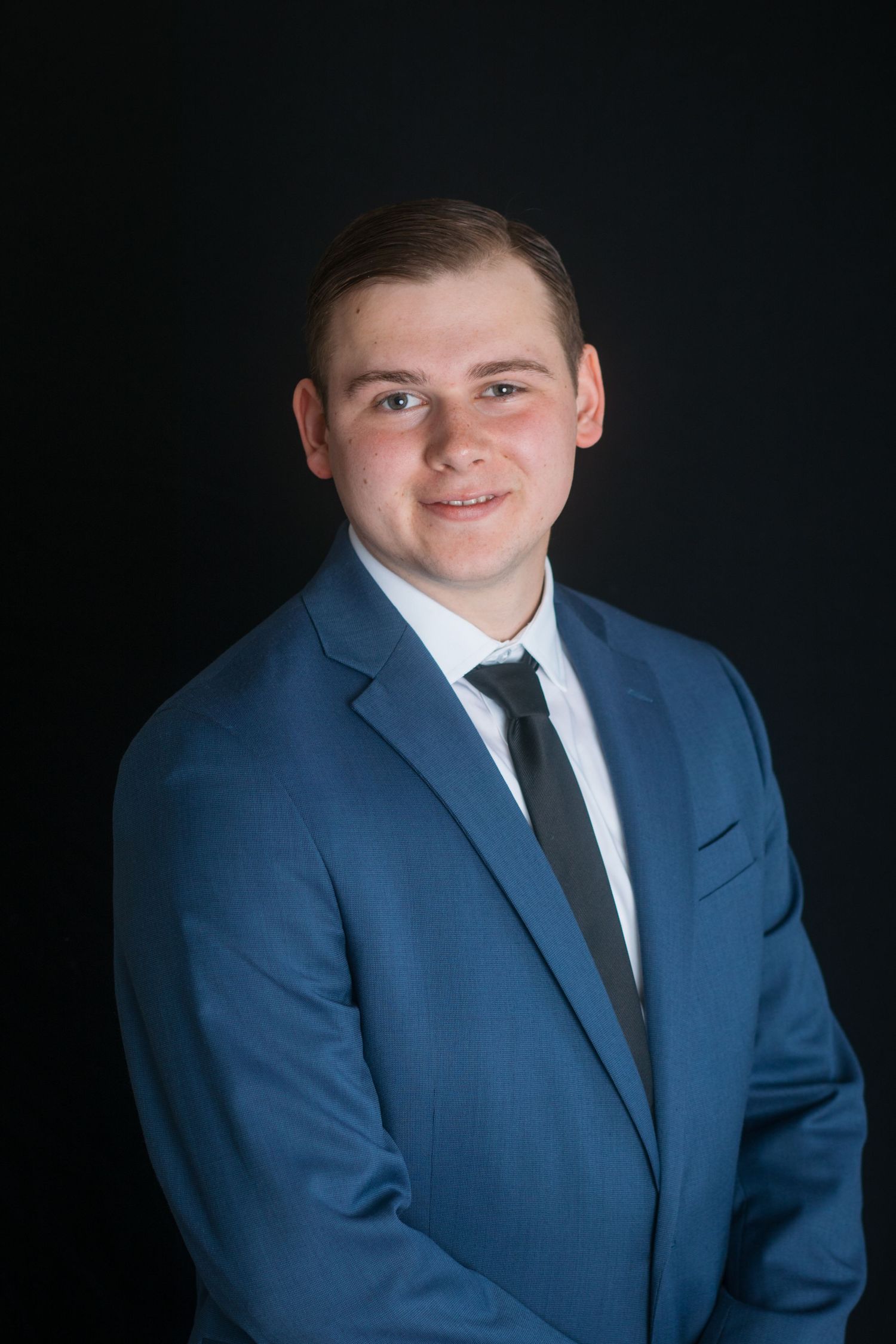 Professional male headshot in blue suit with natural expression, Boise Idaho photographer