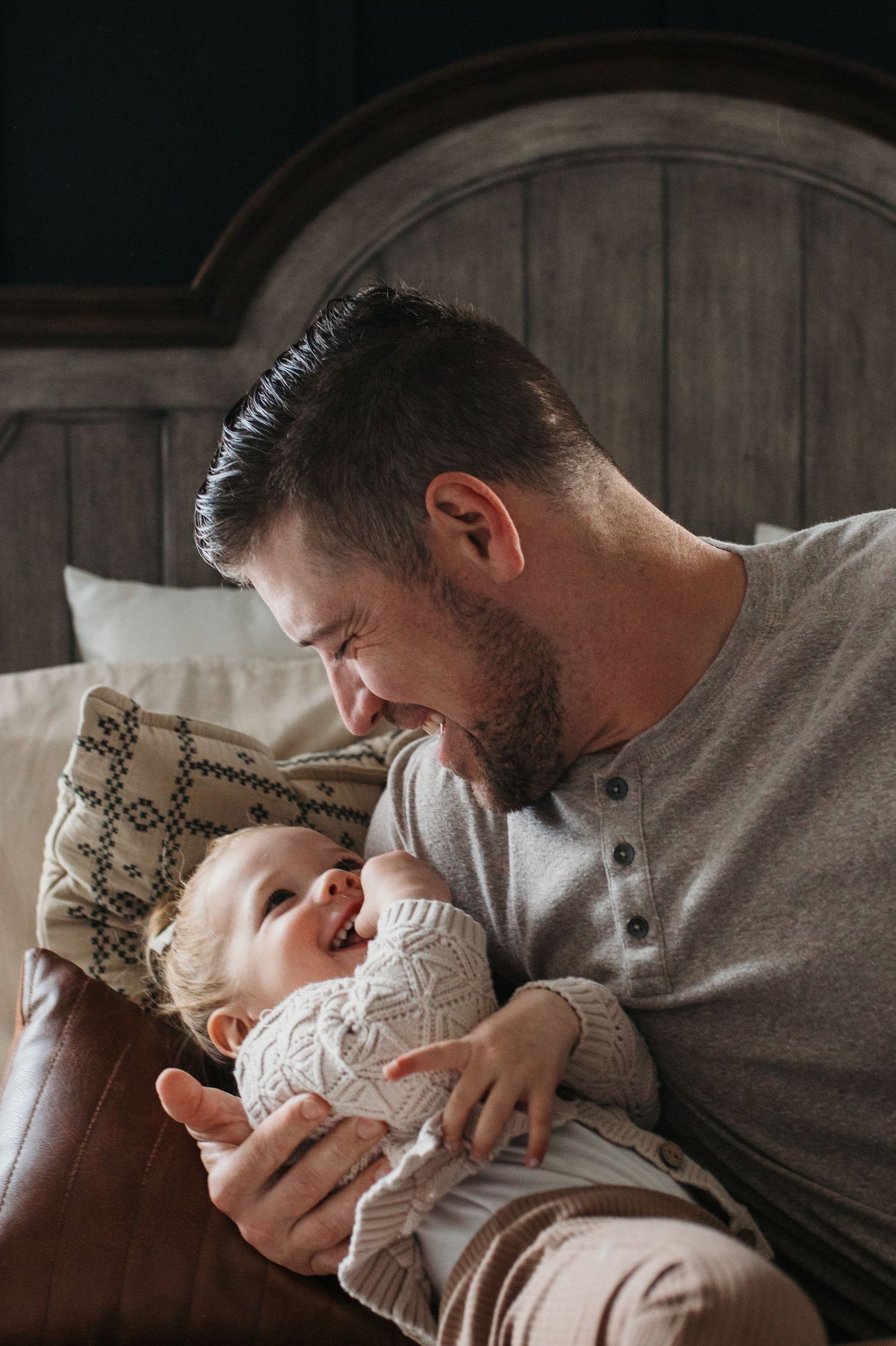 A tender moment captured in a series of photos showing dad and child sharing affectionate cuddles - in-home lifestyle family photos Boise