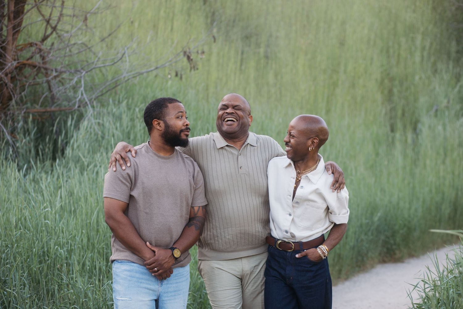 Father sharing a candid moment with adult sons during a spring family photography session at Camel’s Back Park.