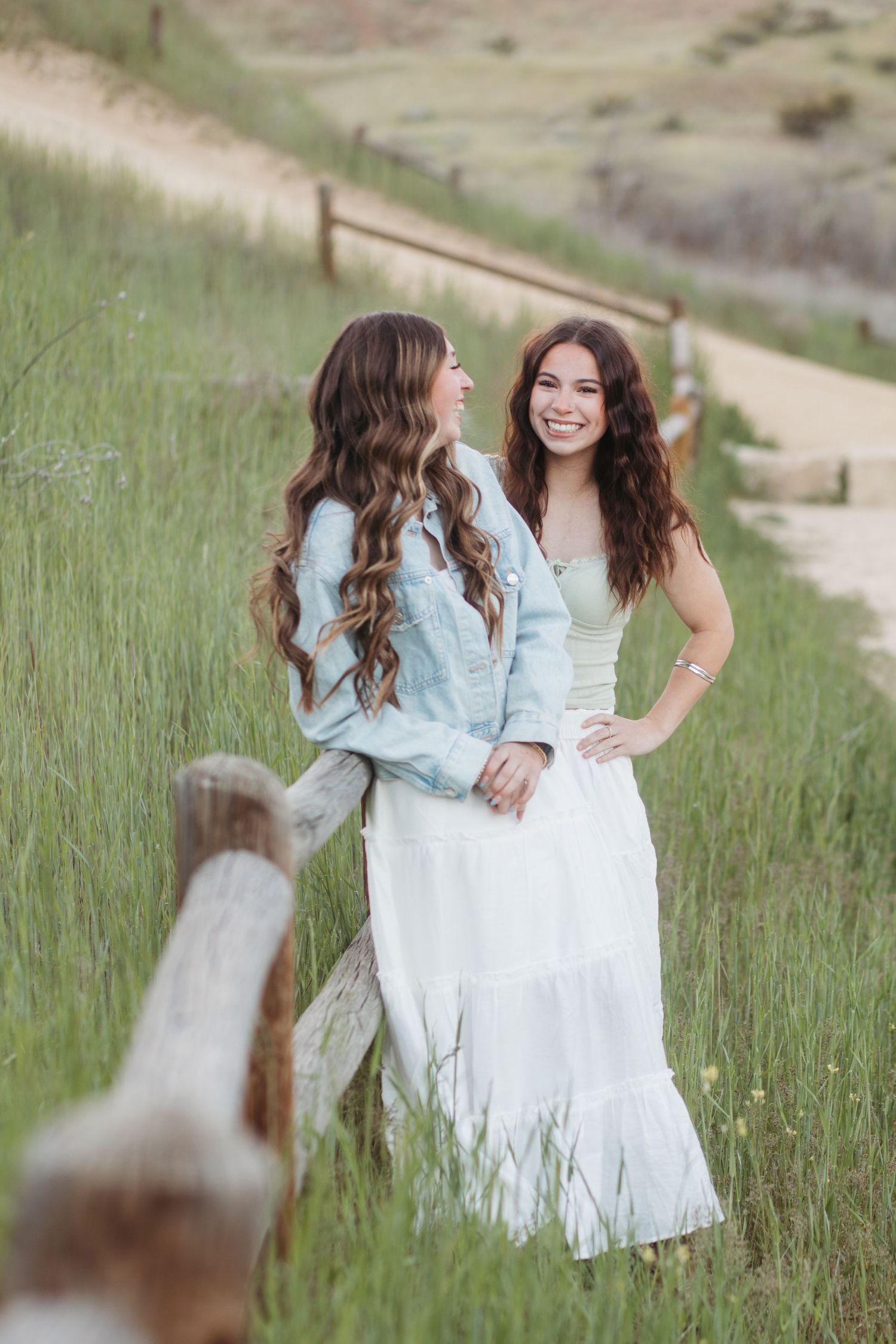 Two best friends laughing together during a relaxed Boise senior photo session outdoors